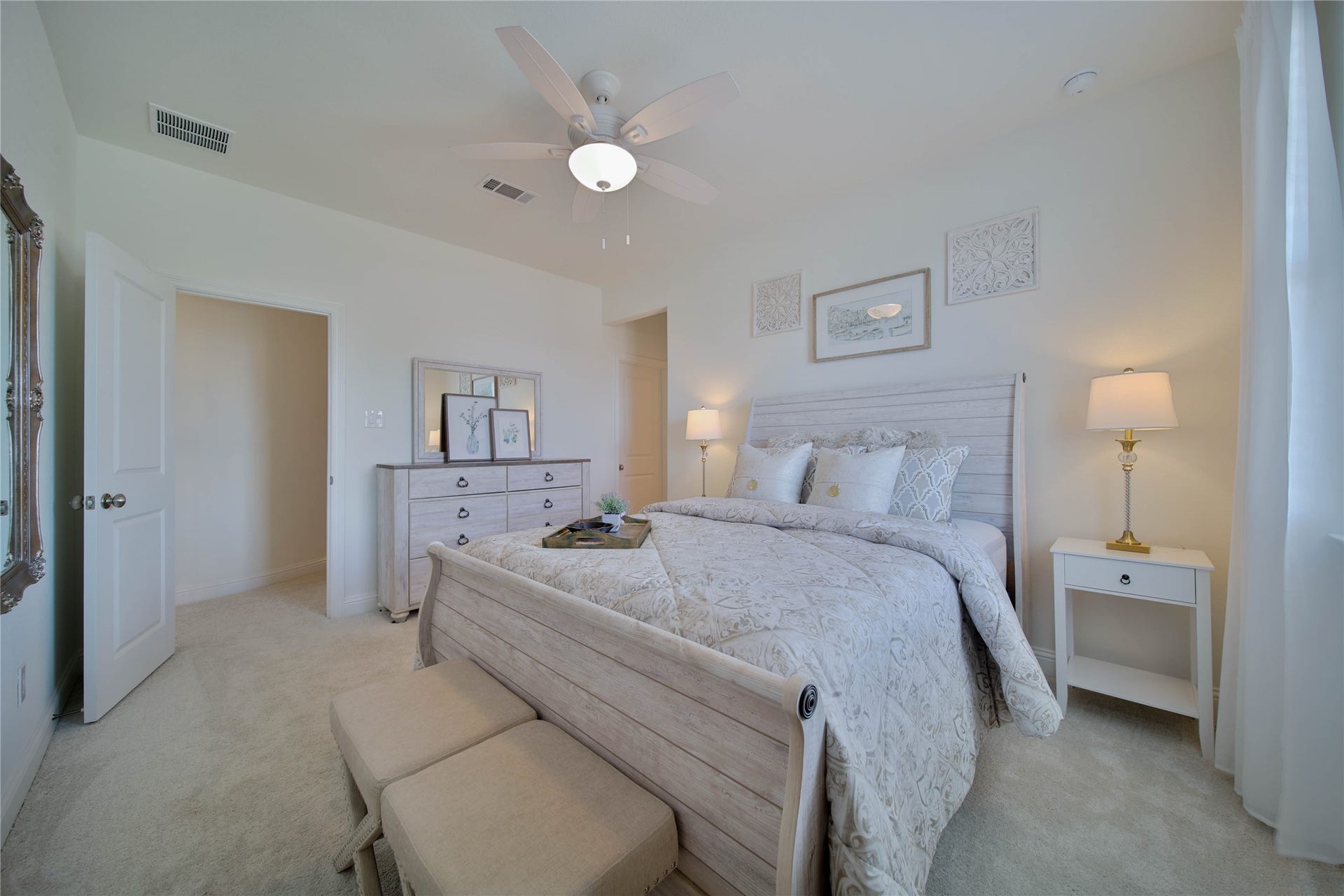 Upstairs, the inviting bedroom features a neutral palette, walk-in closet, ceiling fan, and private ensuite bathroom for added comfort and convenience.