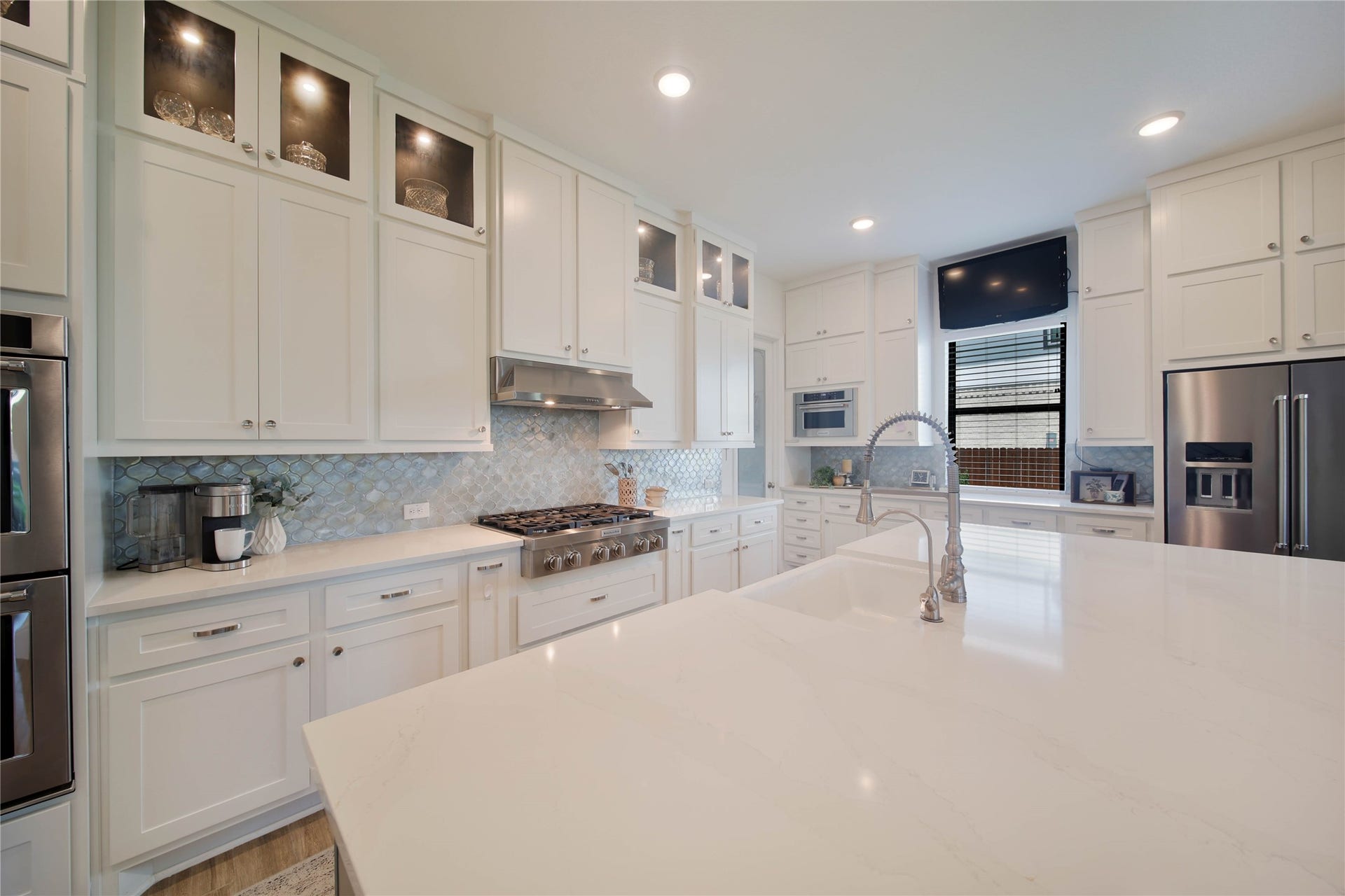 Upgraded cabinetry extends all the way to the ceiling, with glass-front upper cabinets and accent lightingperfect for showcasing your china, crystal, or favorite decorative accessories.