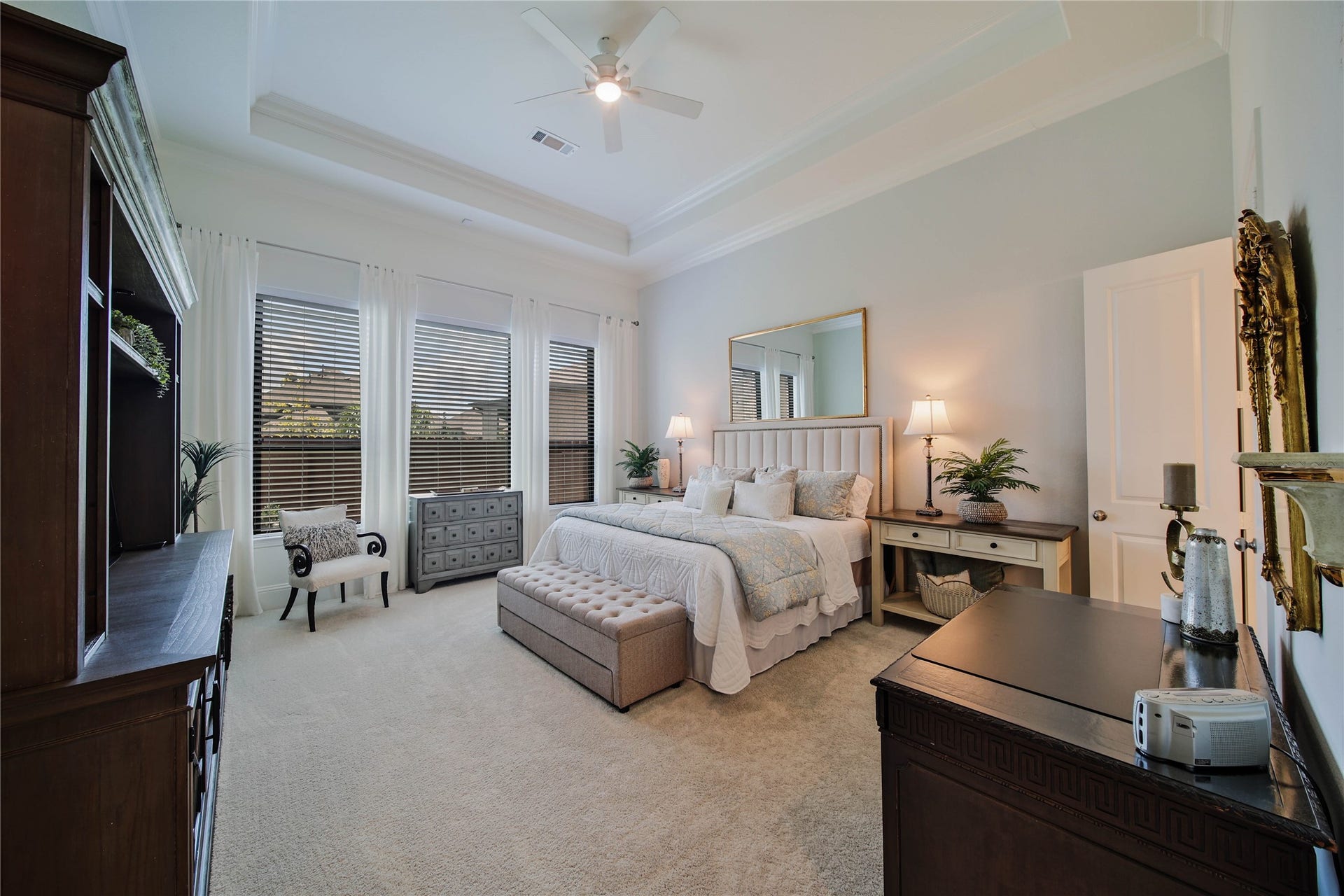 The primary suite is a private escape, featuring beautiful tray ceilings that add an elegant touch and create a warm, inviting ambiance.