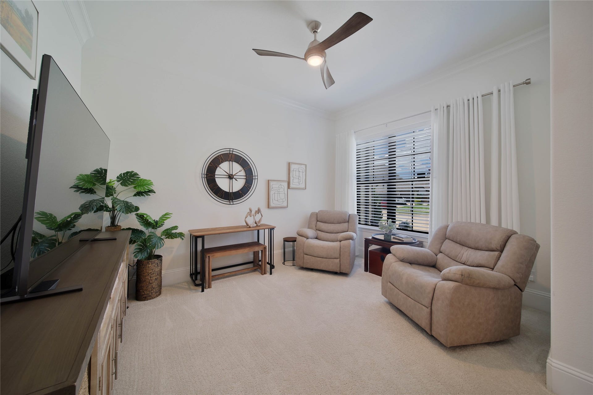 The flexible front room offers endless possibilities, perfect for use as a private study, home office, or comfortable den.