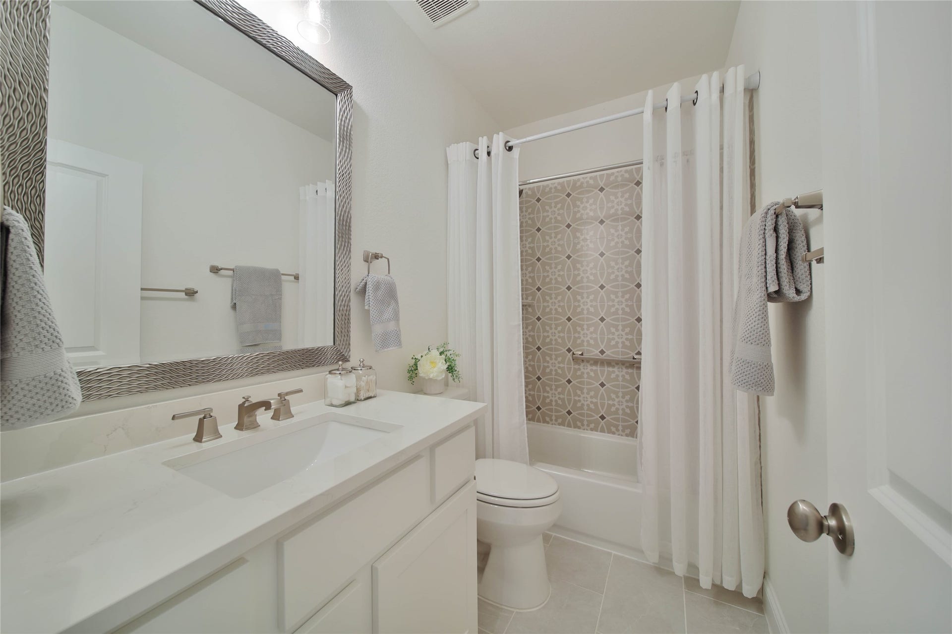 A conveniently located full bathroom in the hallway provides easy access for family members and guests alike.
