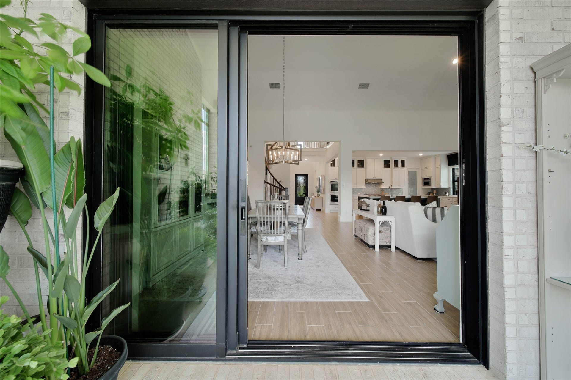 The multi track sliding doors in the dining area stack wide open, seamlessly blending the indoor and outdoor spaces and creating an incredible setting for entertaining on the back patio.