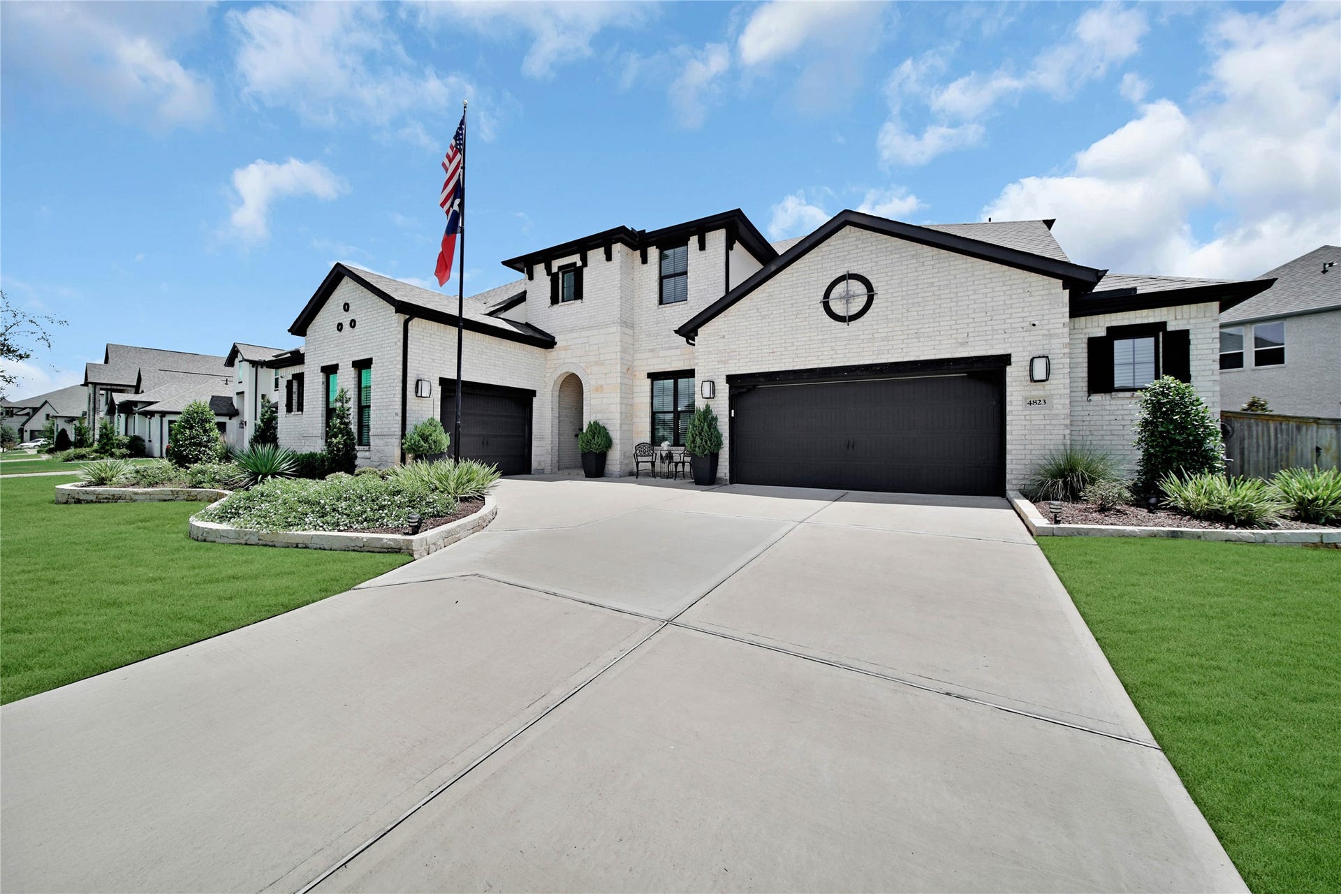 An oversized two-car garage includes a workbench and houses both tankless water heaters, while the additional single-carriage garage offers even more storage or an extra parking space.