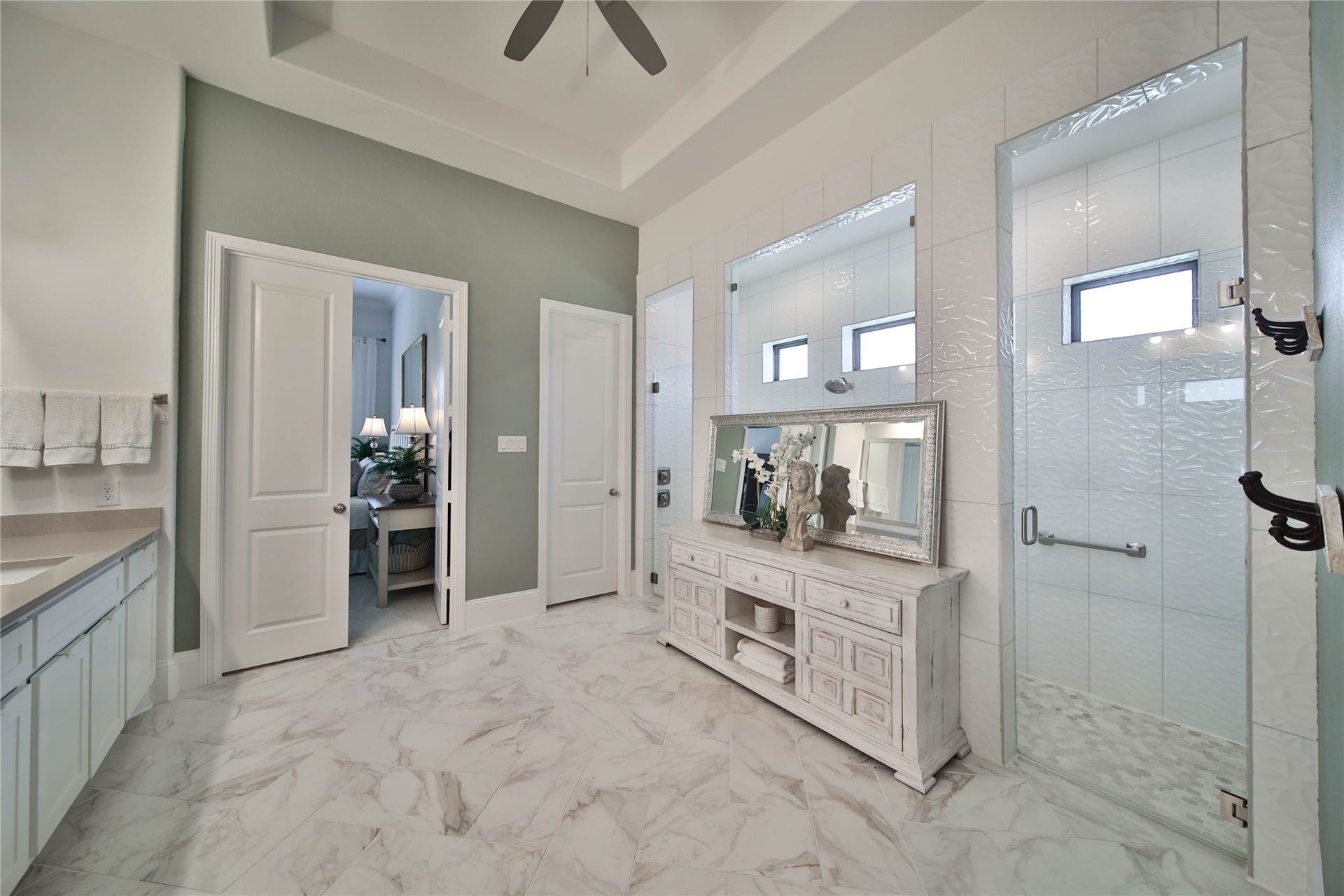 A serene primary bath features an oversized shower, with plumbing already in place should the new homeowner wish to add a soaking tub in the future.
