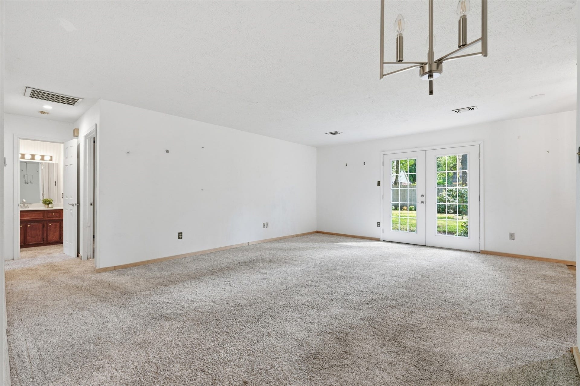 23 Thrush Grove Place, The Woodlands, TX 77381 Living room with double doors to back yard