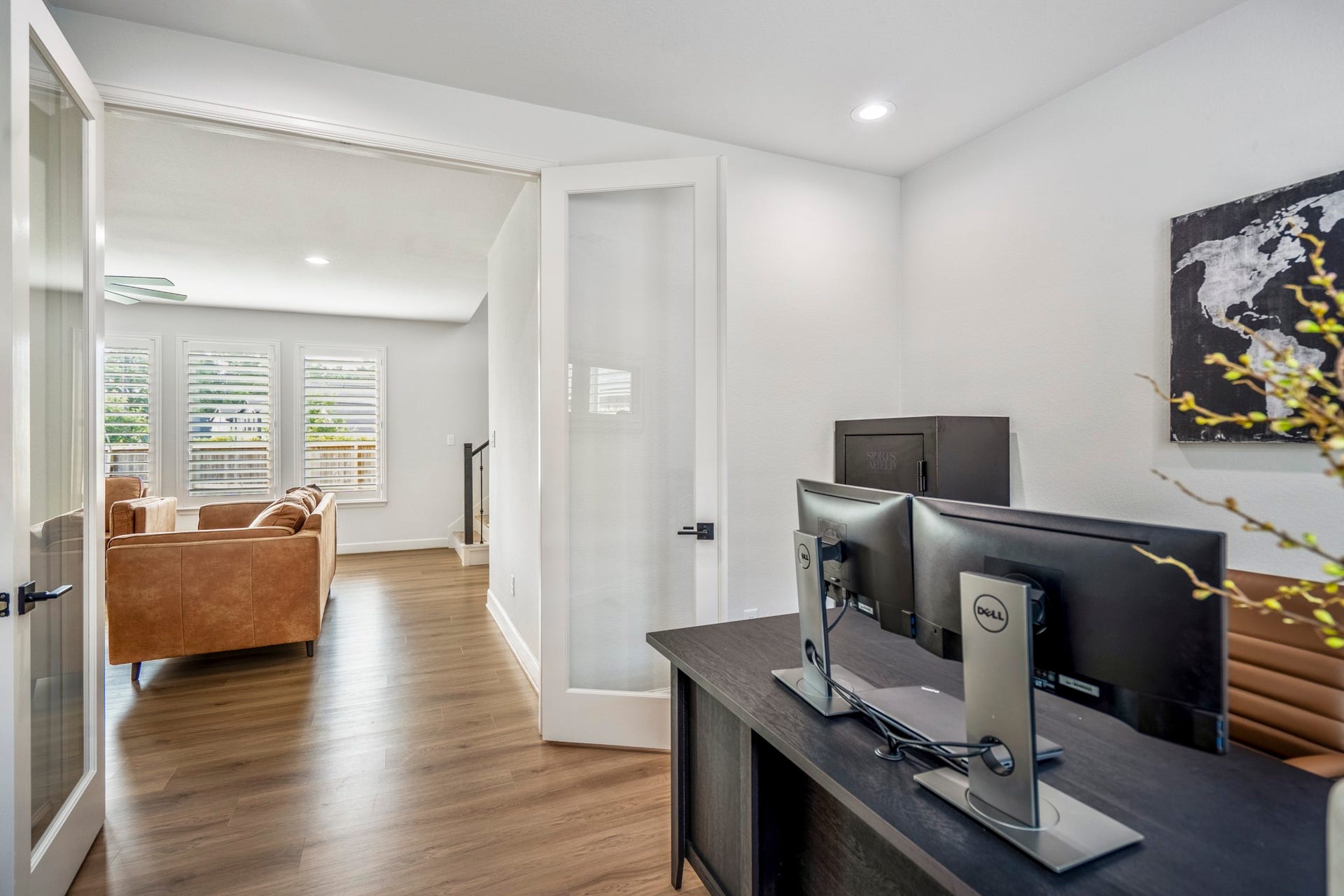 304 Mullins Court, Montgomery, TX 77316 This modern home office with double glass doors and continuous LVP flooring sits just off the living room.