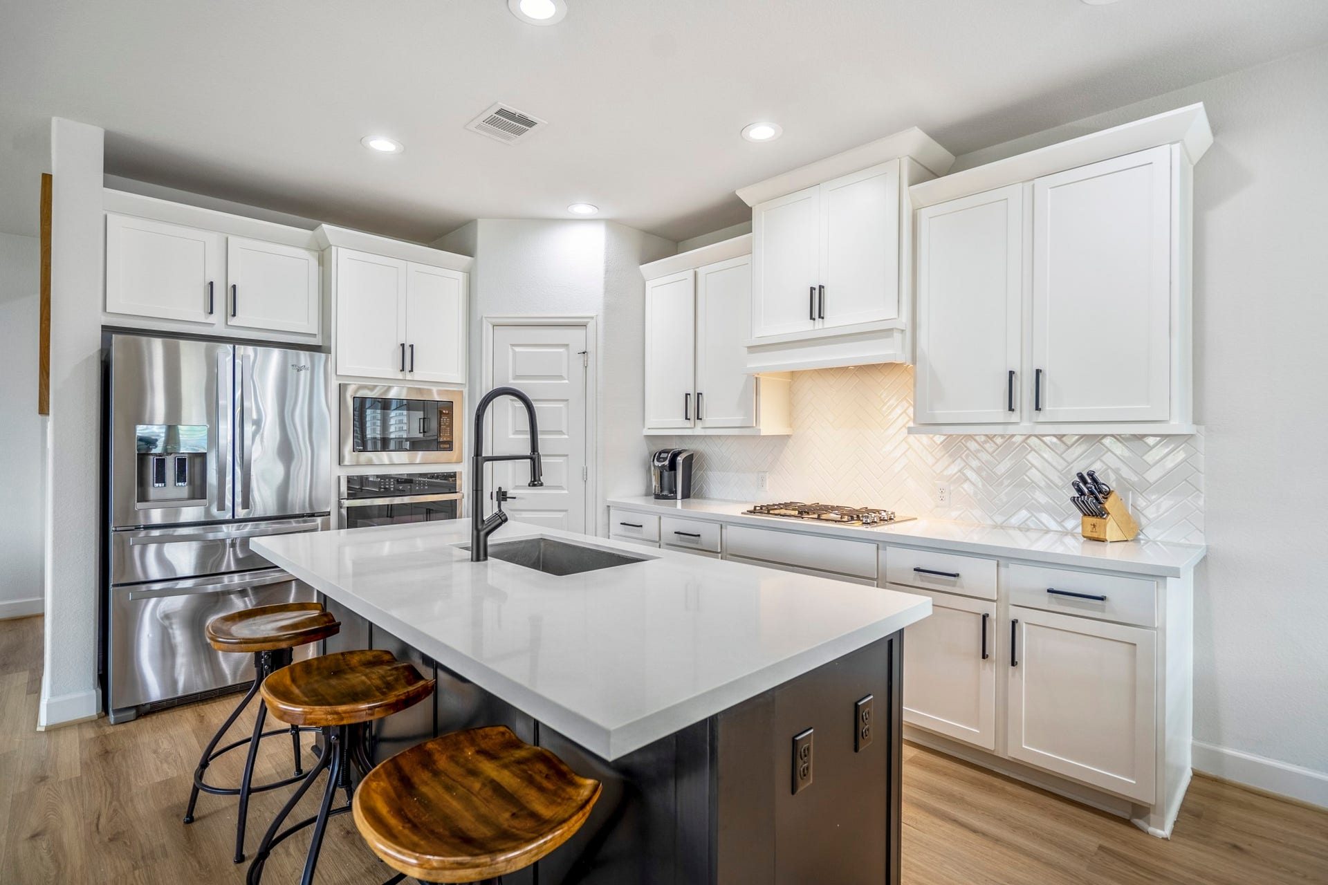 304 Mullins Court, Montgomery, TX 77316 The herringbone backsplash and recessed lighting add a touch of elegance to the space.