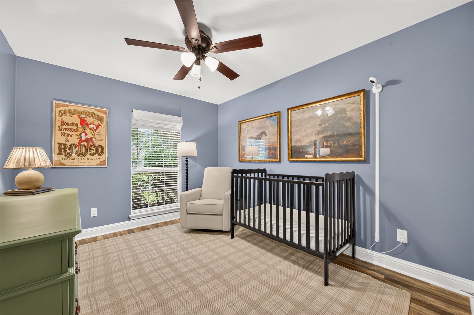 This charming secondary bedroom is currently styled as a tranquil nursery, offering a versatile space perfect for a kids' room, guest bedroom, or second home office.