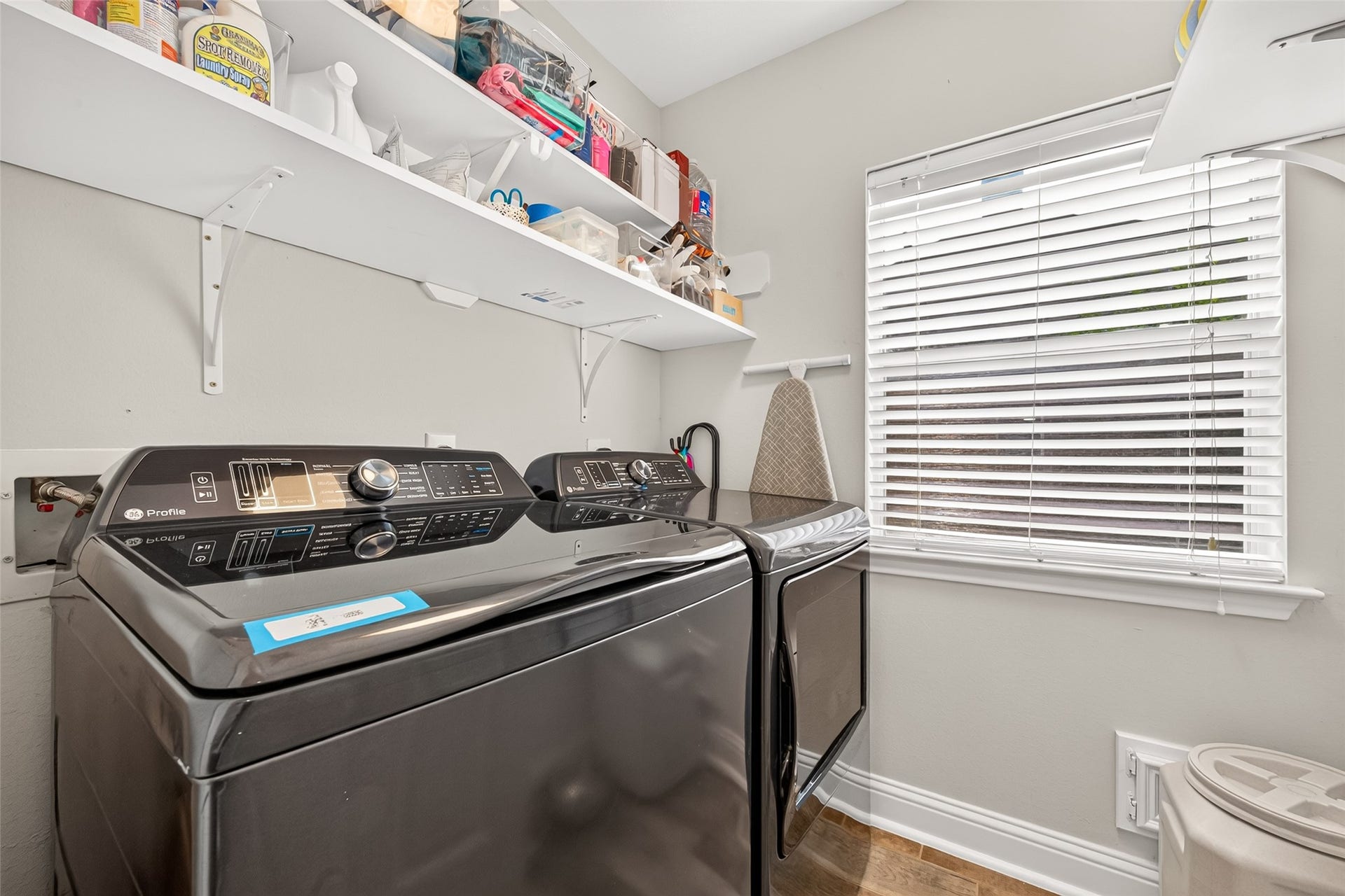 This dedicated utility room makes laundry day an absolute breeze with its smart storage solutions and bright, functional design. The space is well-prepared to handle all household laundry needs with ease.