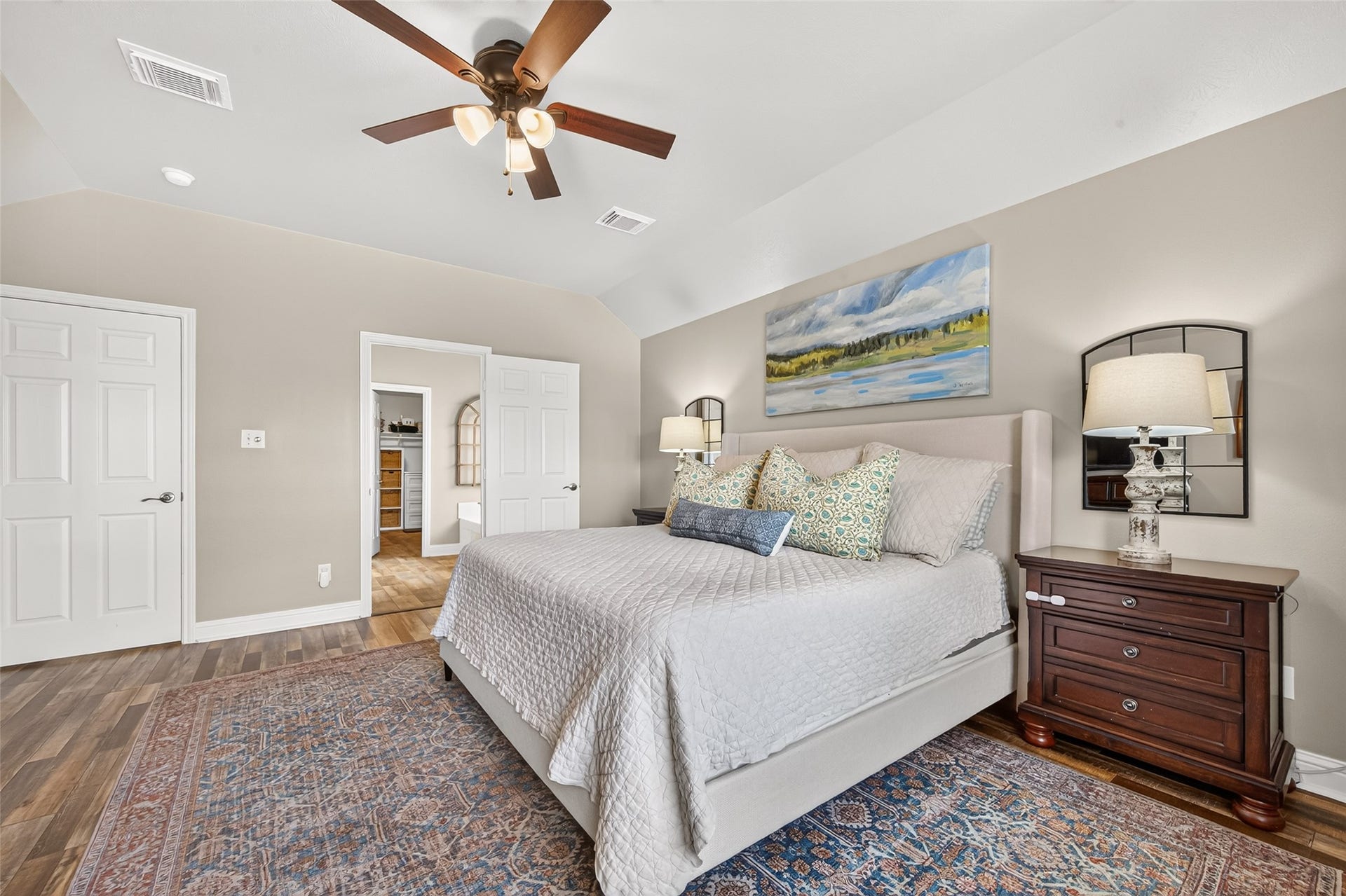 High tray ceilings accentuate the room's generous proportions, complete with a traditional wood-blade ceiling fan to keep the space cool and comfortable year-round.