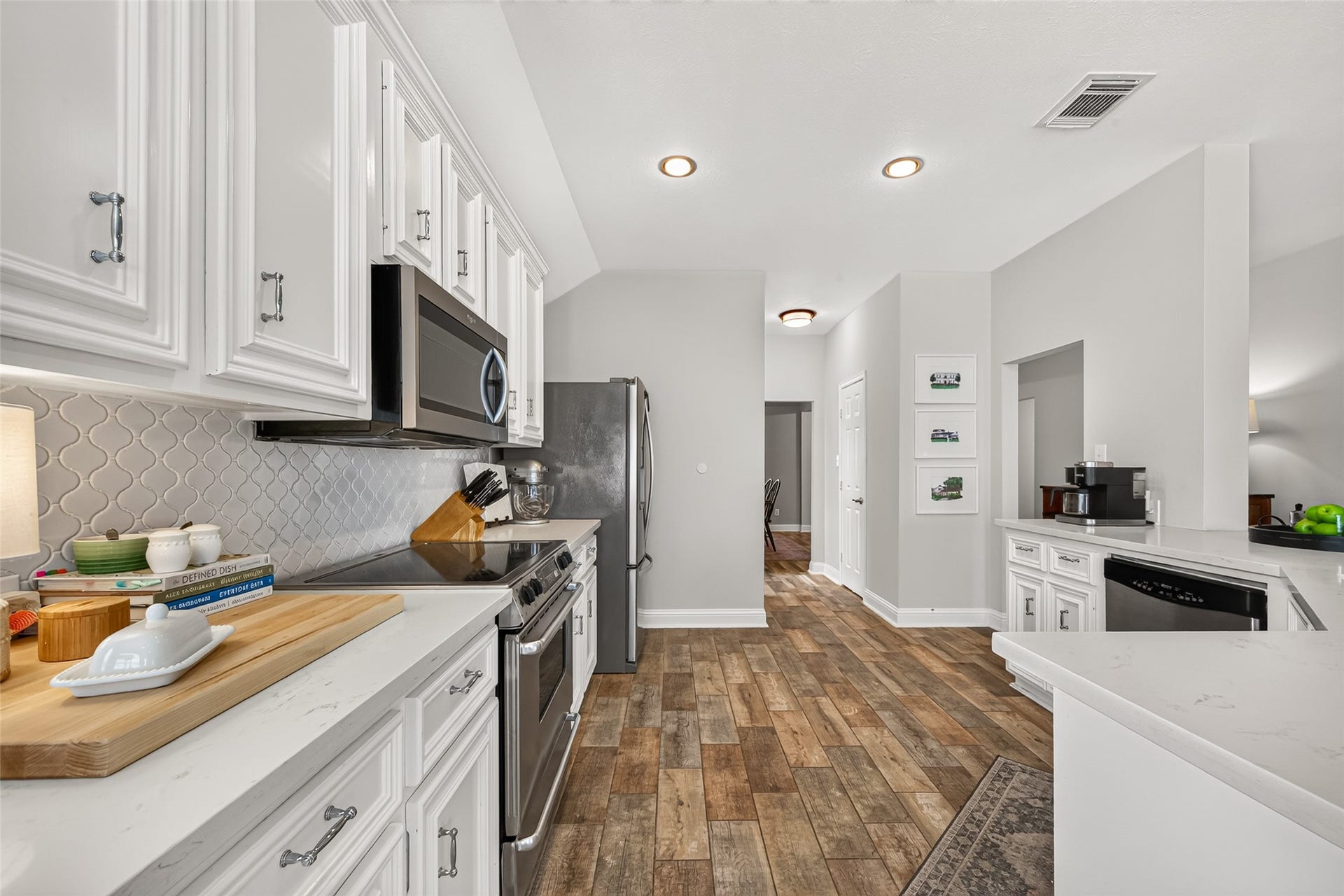 This kitchen is built for memoriespicture laying out a massive spread for holiday parties, with ample solid-surface counter space for prepping dishes and an expansive island where guests can gather, chat, and grab appetizers.