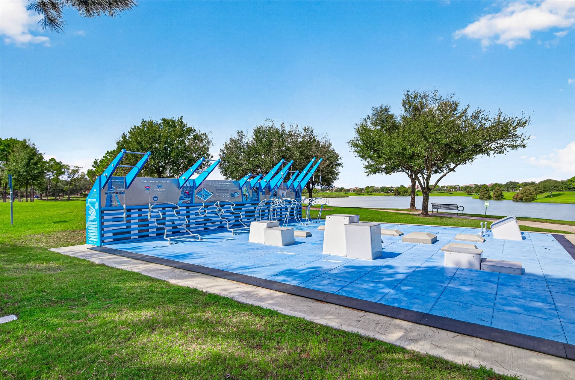 Promoting a healthy, active lifestyle, this state-of-the-art outdoor National Fitness Court provides an exceptional bodyweight workout station right along the community's scenic lakefront trail. Set on a vibrant blue safety surface, the facility features integrated equipment for plyometrics, squats, pushes, pulls, core training, and agilities, complete with clear instructional wall graphics to guide your routine.