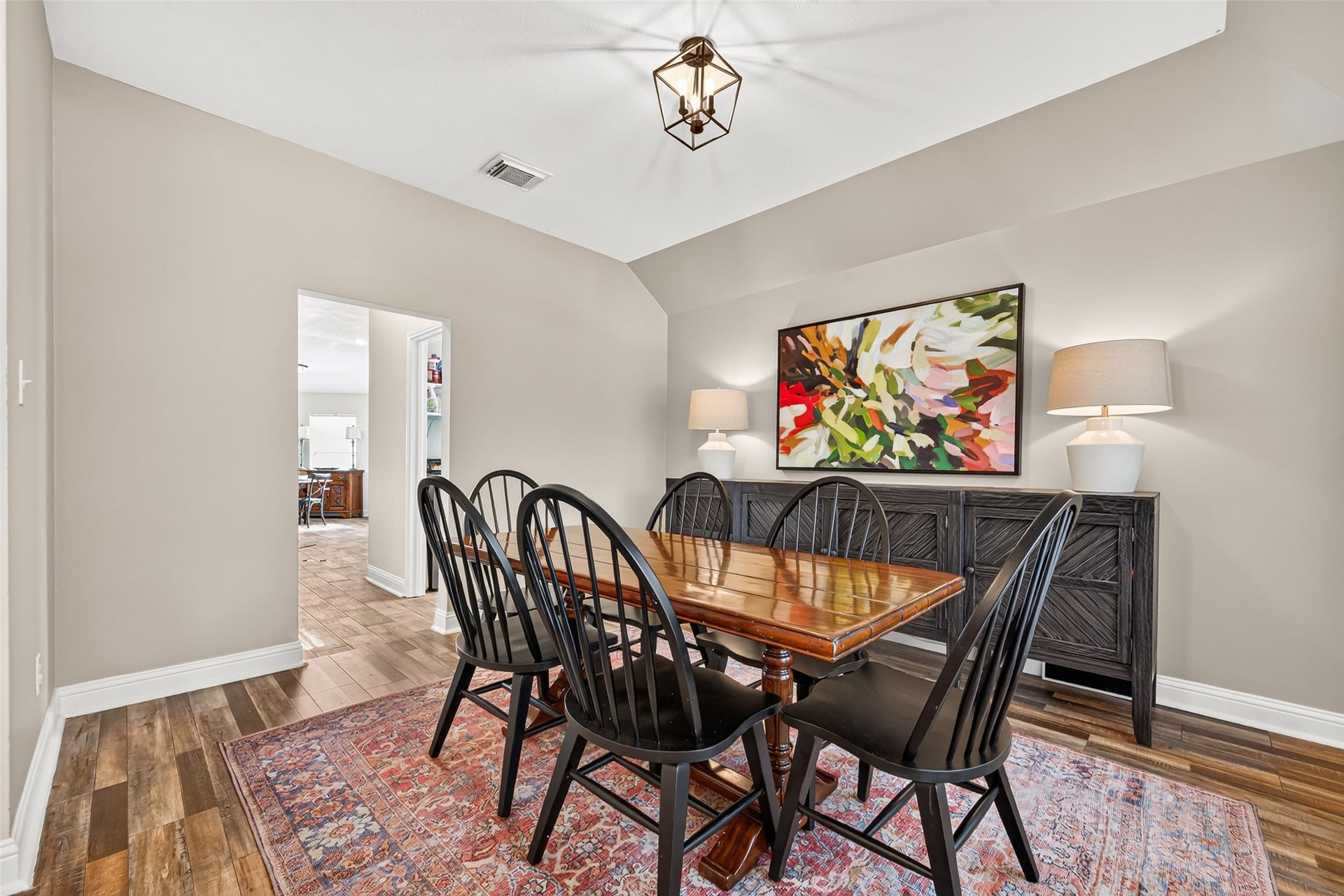 This formal dining room radiates warmth and sophistication, creating an ideal setting for intimate dinner parties and holiday gatherings alike.
