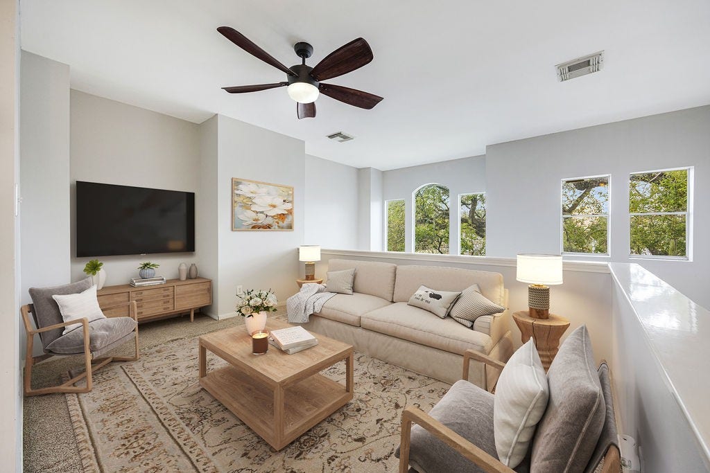 Framed by treetop views and natural light, the third floor loft is a standout space. Image has been virtually staged.