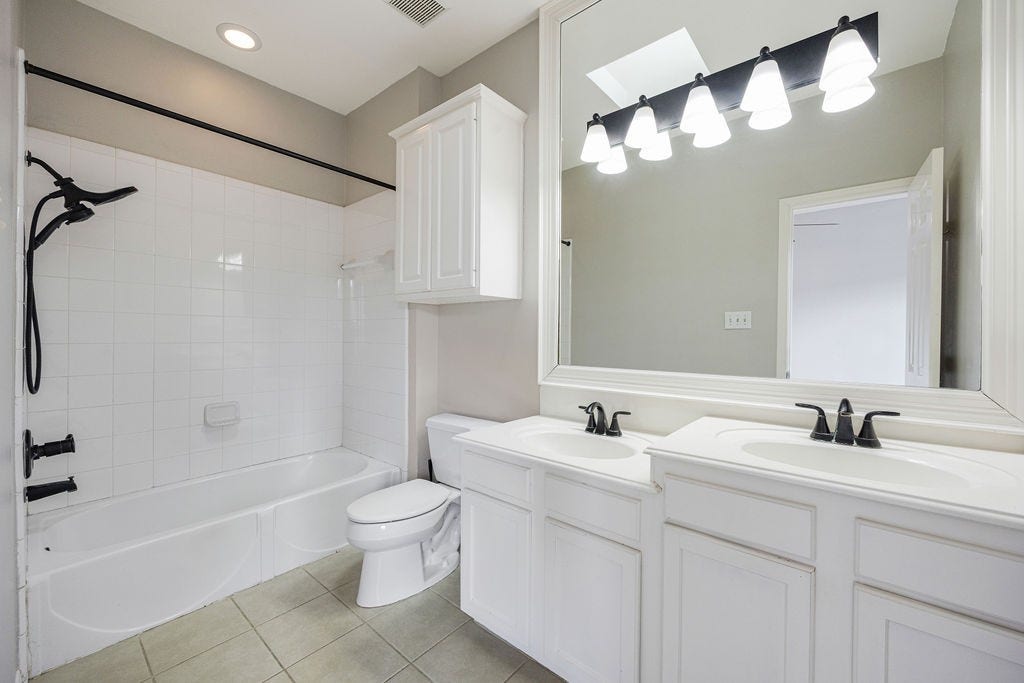 A clean, classic ensuite with double vanities and plenty of counter space.