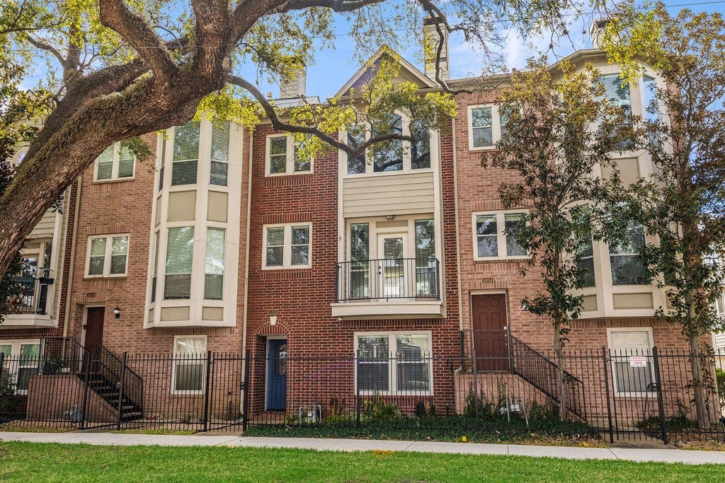 1410 Tuam is a 2 bed, 2 bath Midtown townhome with classic brick architecture, a tree-lined setting, and a private gated entry.