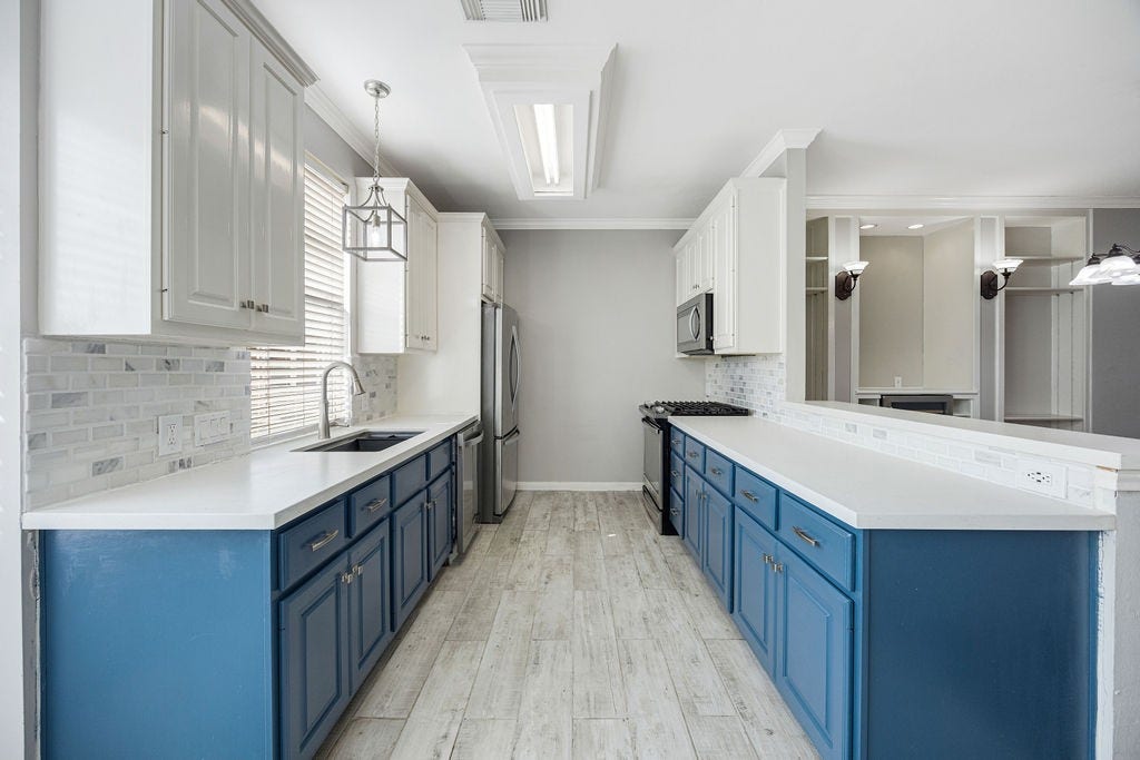 Long lines, generous counter space, and cabinetry that makes a statement.