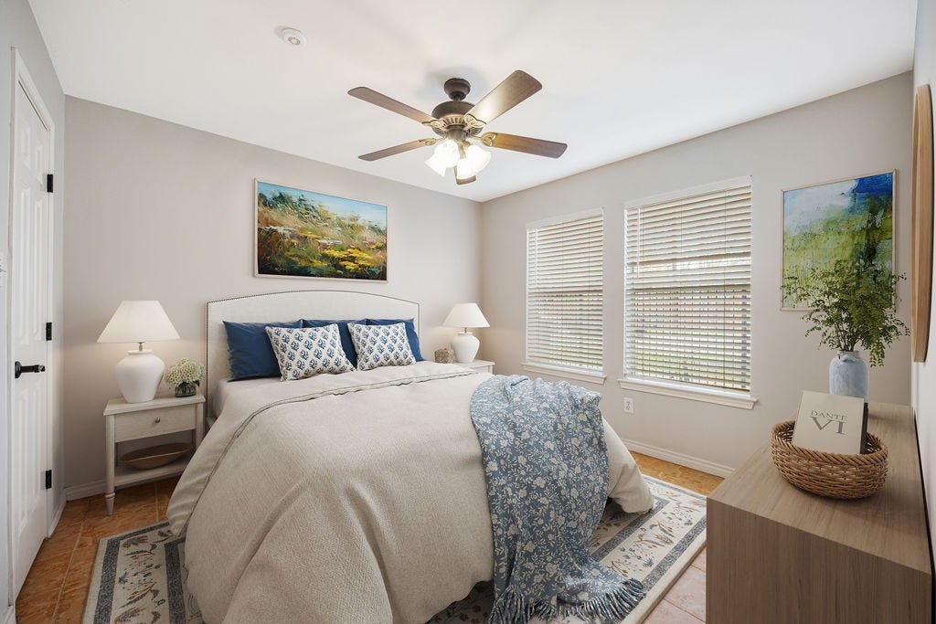 Located on the first floor, this bedroom offers separation from the main living areas above. Image has been virtually staged.