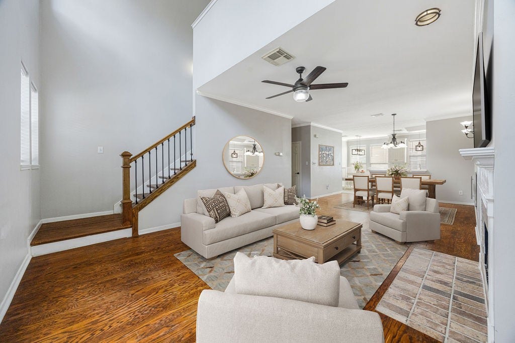 High ceilings, warm wood floors, and sightlines that stretch from living to dining. This main level delivers. Image has been virtually staged.
