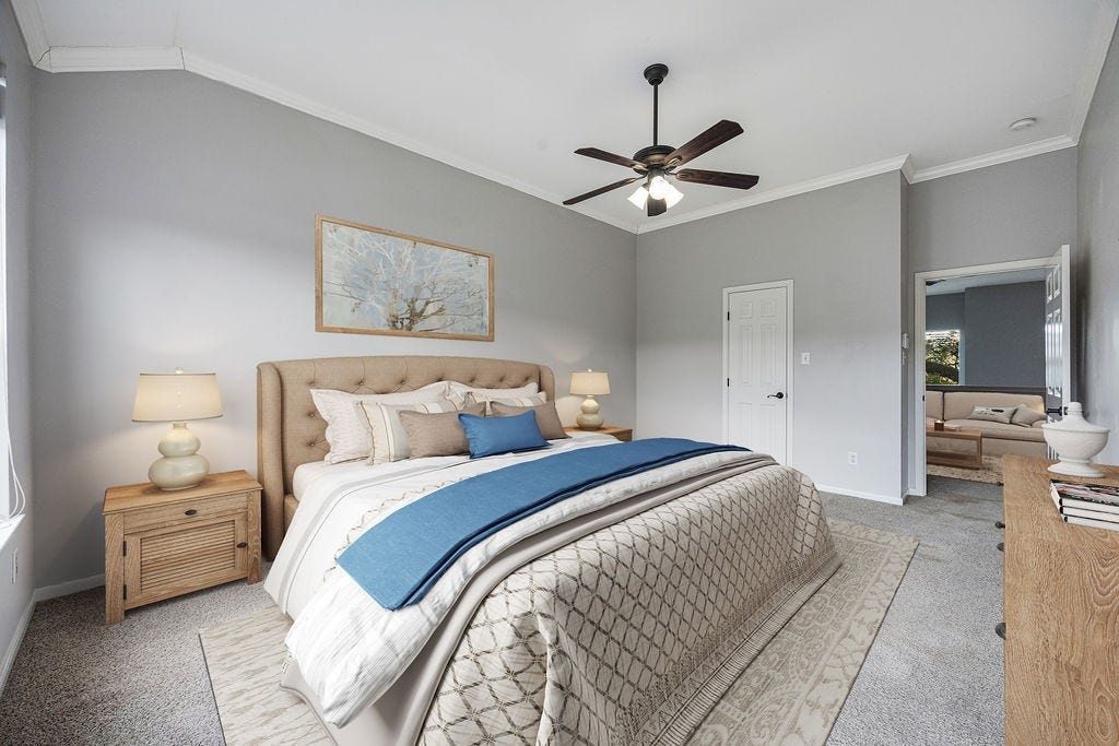 Generous in scale and filled with natural light, the primary suite offers space to truly settle in. Image has been virtually staged.