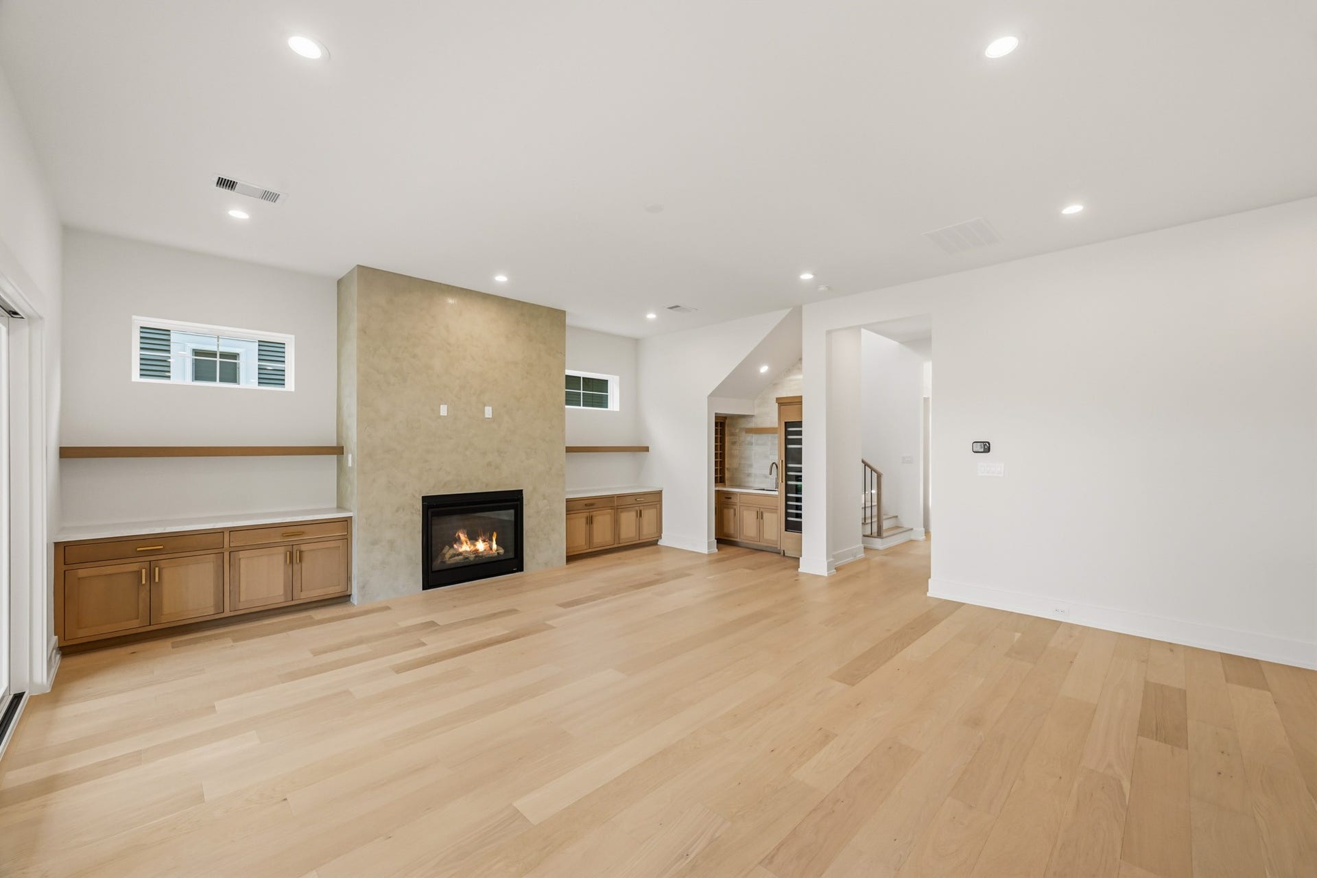 Custom built-ins and transom windows flank the fireplace!