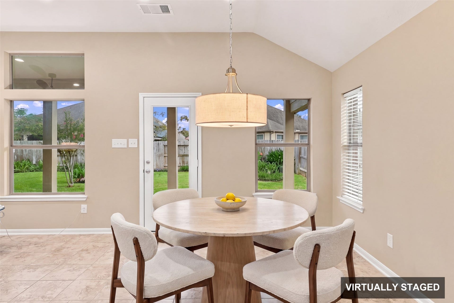 24015 Orange Orchard Lane, Katy, TX 77493 Virtually staged. The breakfast nook is surrounded by windows, with a door to the patio for coffee outside.
