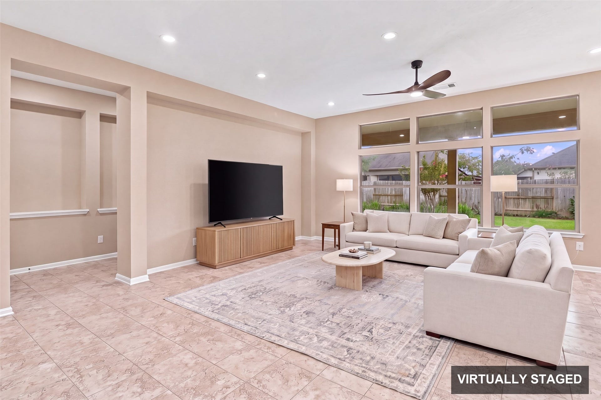 24015 Orange Orchard Lane, Katy, TX 77493 Virtually staged. Built-in niches line the family room wall, with room for a large media setup and a sectional without crowding the walkways.