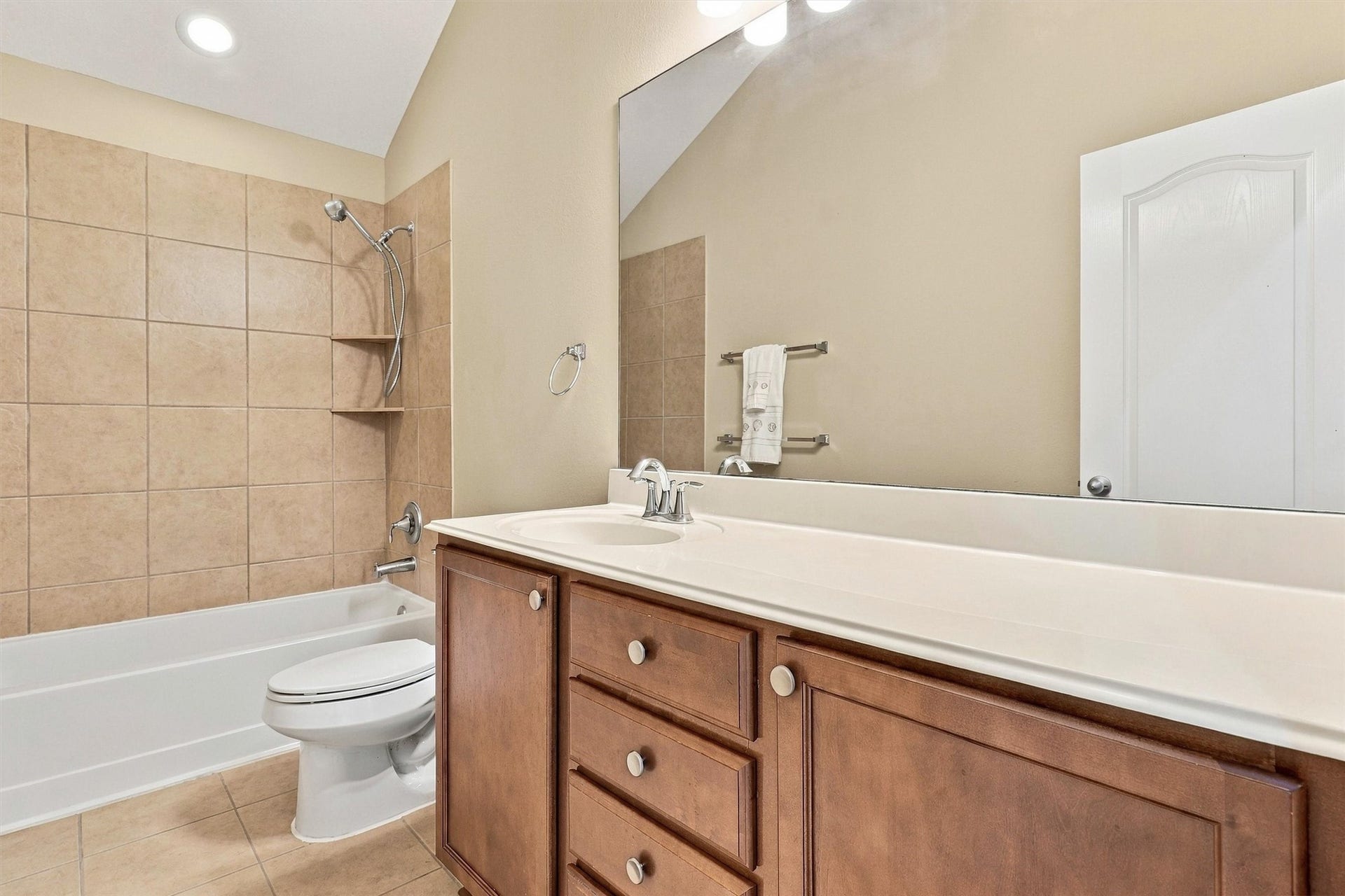 24015 Orange Orchard Lane, Katy, TX 77493 The secondary bath has a full tub-and-shower combination and a long vanity with drawer storage.