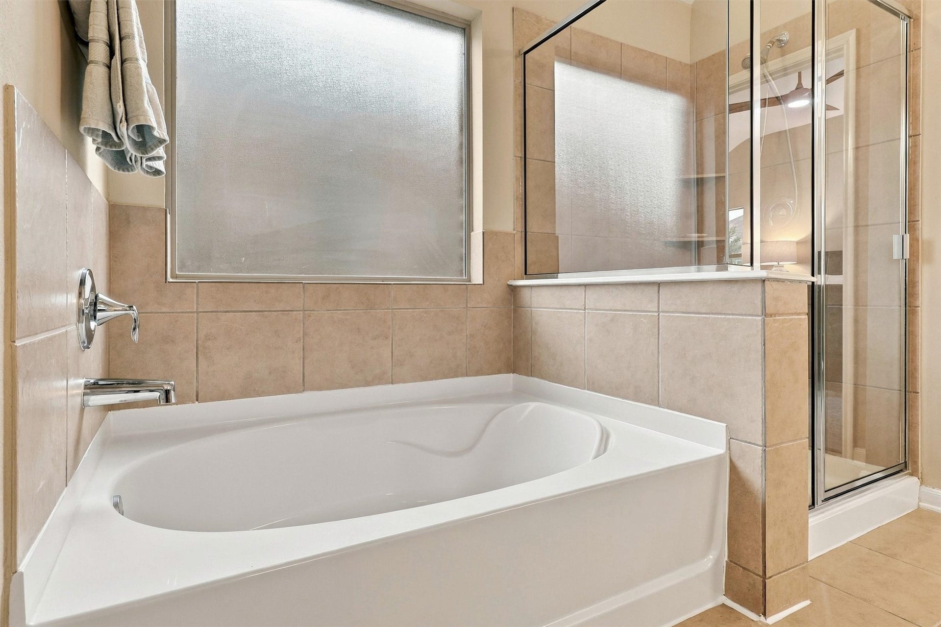 24015 Orange Orchard Lane, Katy, TX 77493 Frosted glass above the tub brings in daylight while keeping the bath fully private.