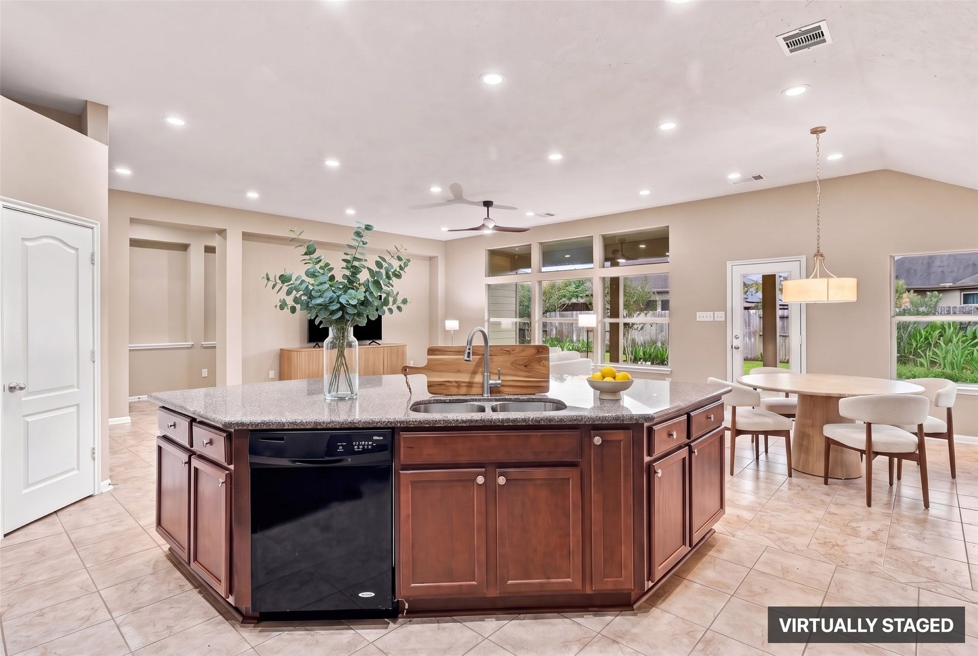 24015 Orange Orchard Lane, Katy, TX 77493 Virtually staged. The sink and dishwasher sit in the island, so cleanup happens facing the room while the perimeter counters stay free for prep.