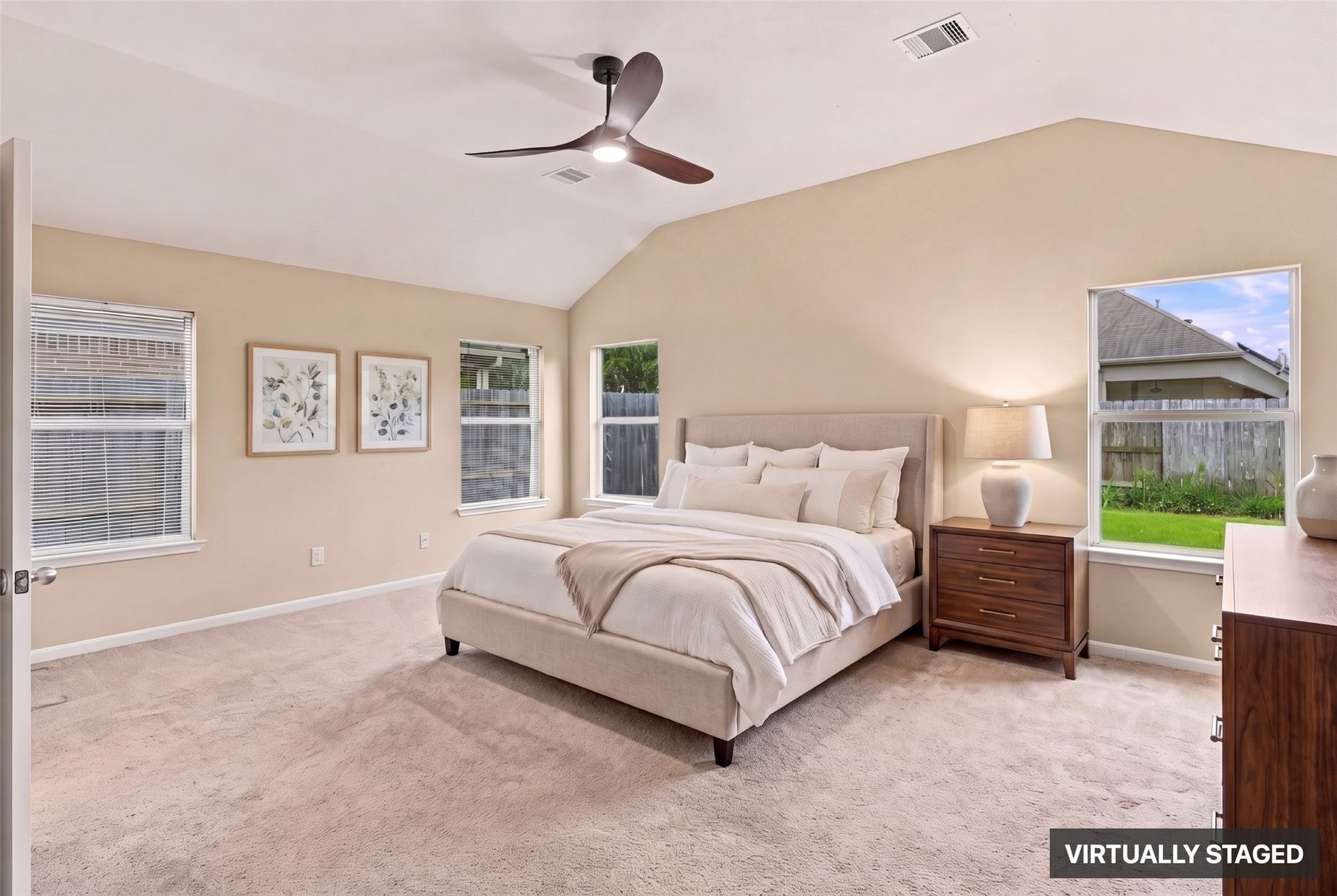24015 Orange Orchard Lane, Katy, TX 77493 Virtually staged. The primary suite sits at the back of the house under a high ceiling, with windows on two walls facing the yard.