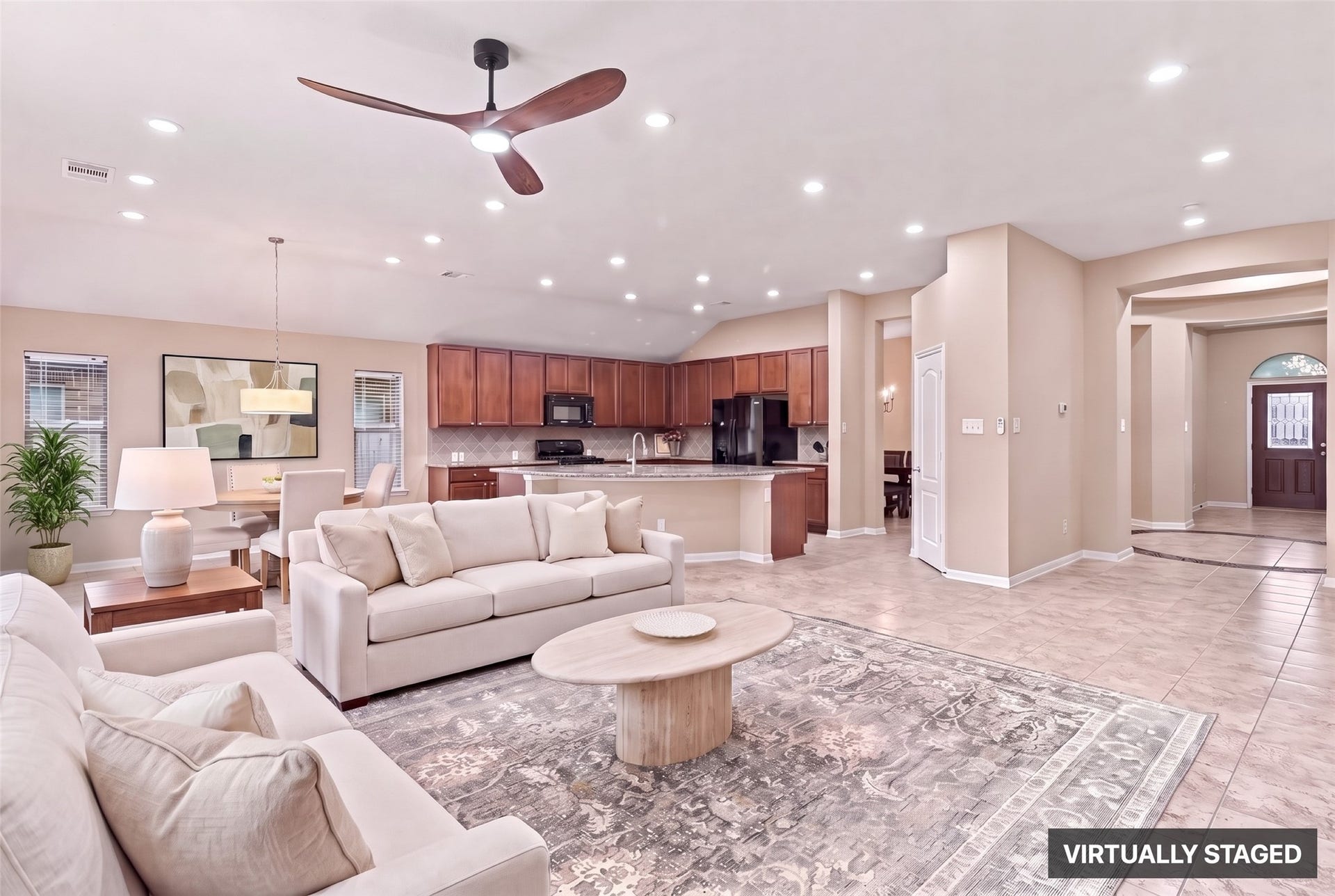 24015 Orange Orchard Lane, Katy, TX 77493 Virtually staged. Family room, breakfast area and kitchen flow as one open space, so whoever is cooking stays part of the conversation.