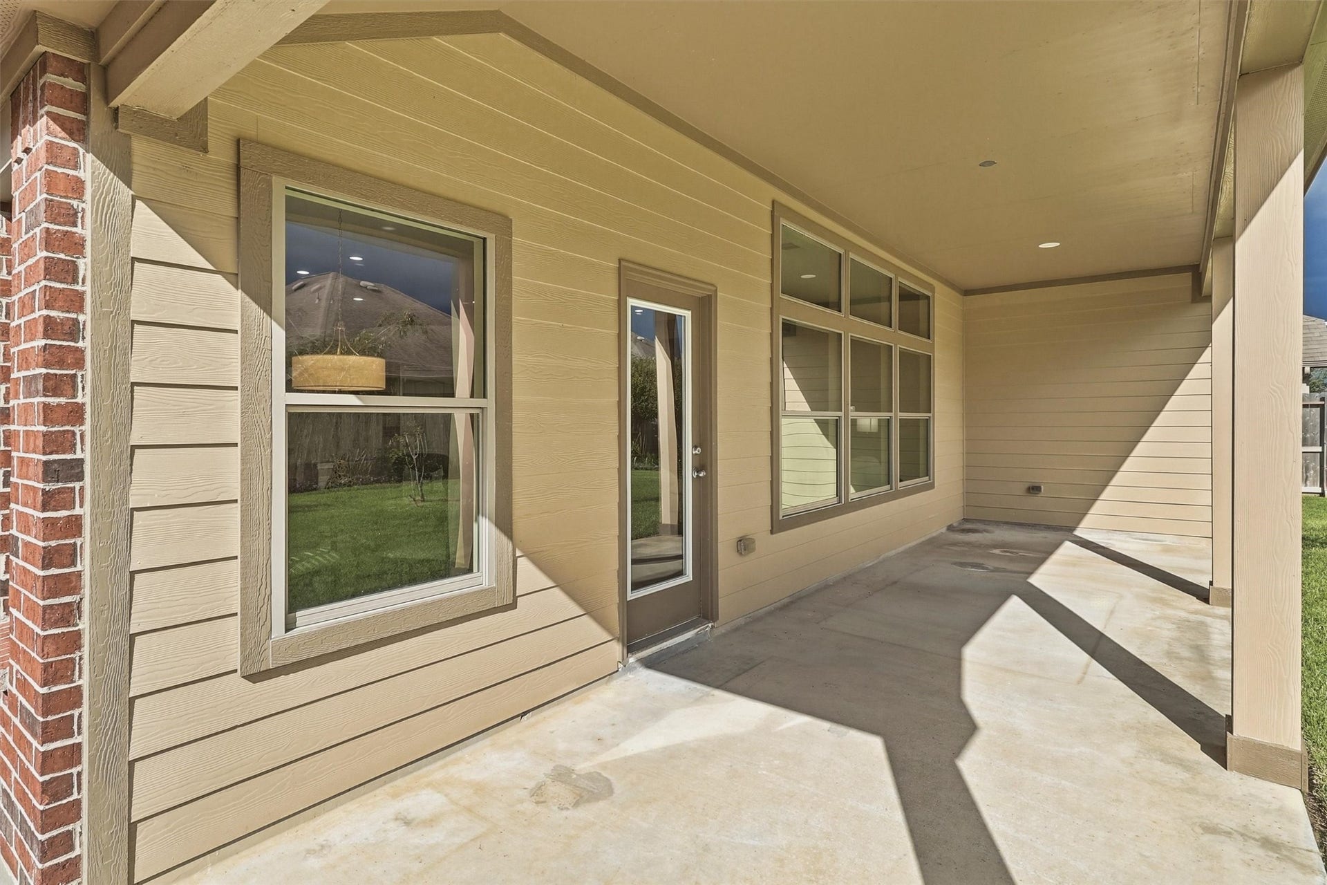 24015 Orange Orchard Lane, Katy, TX 77493 The covered patio runs across the back of the house, shaded for afternoons outside in the Katy heat.