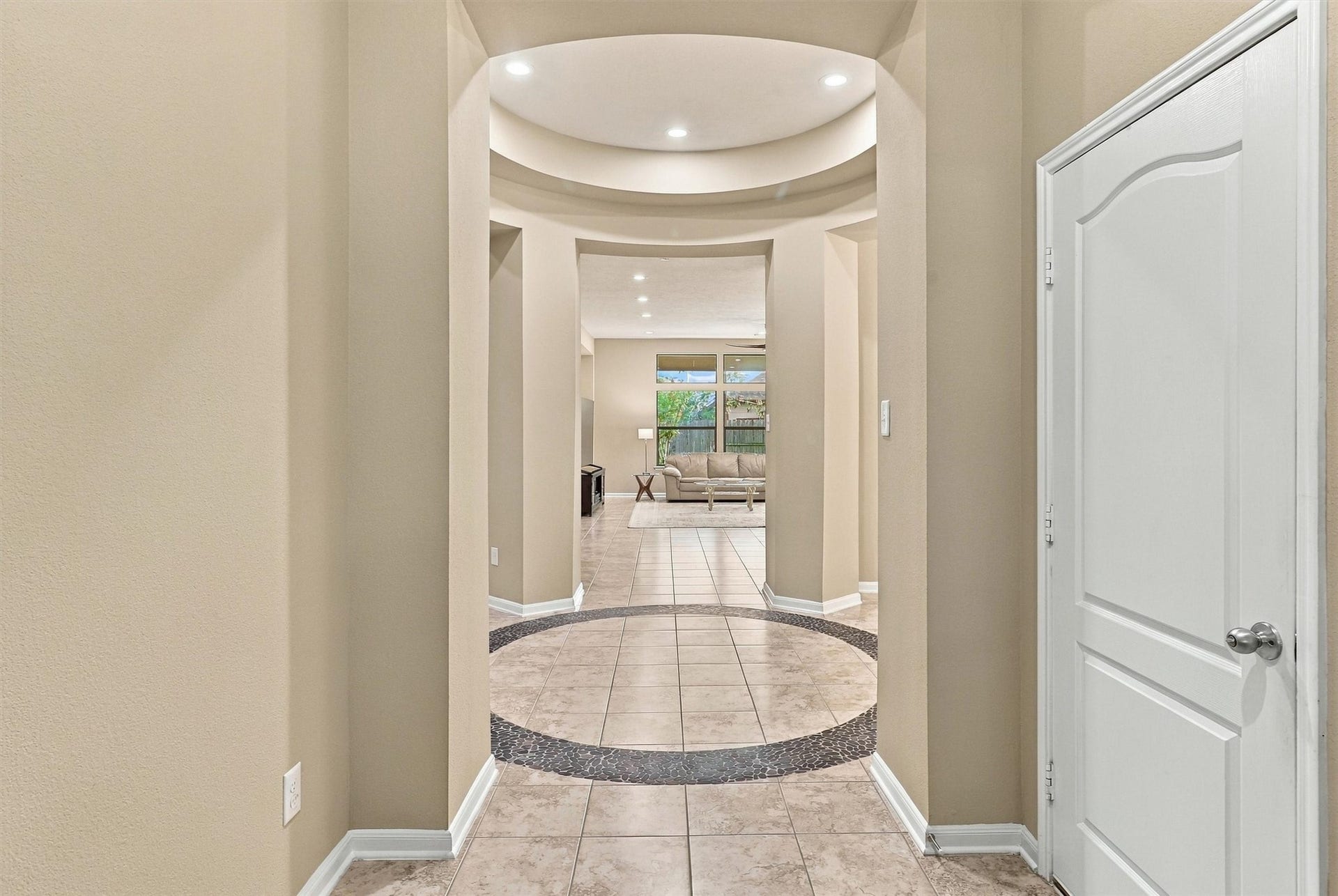 24015 Orange Orchard Lane, Katy, TX 77493 Columns and arched openings divide the foyer from the living areas, so the house reads as distinct spaces without closing anything off.