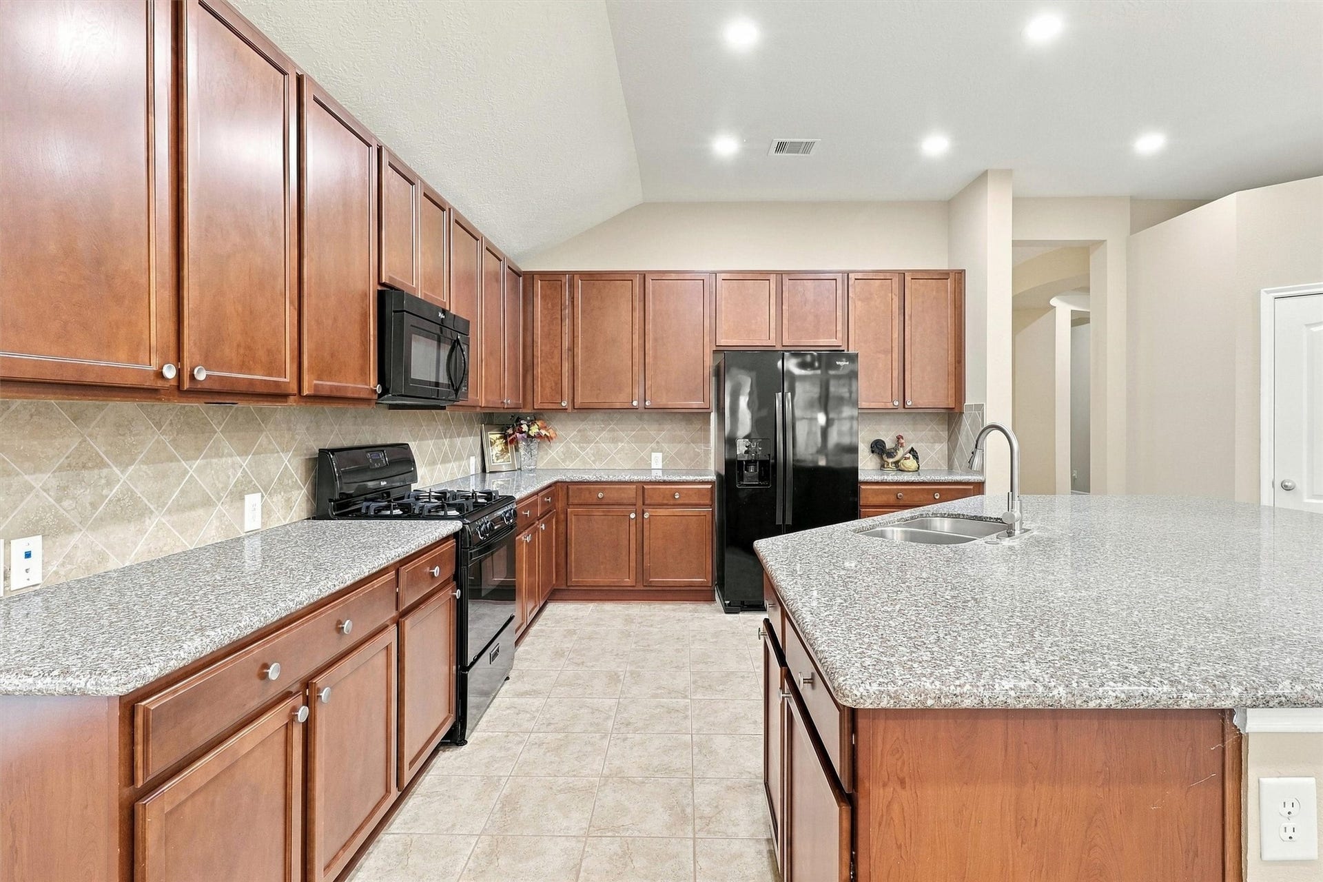 24015 Orange Orchard Lane, Katy, TX 77493 Upper and lower cabinets line every wall of the kitchen - storage that keeps the granite counters clear.