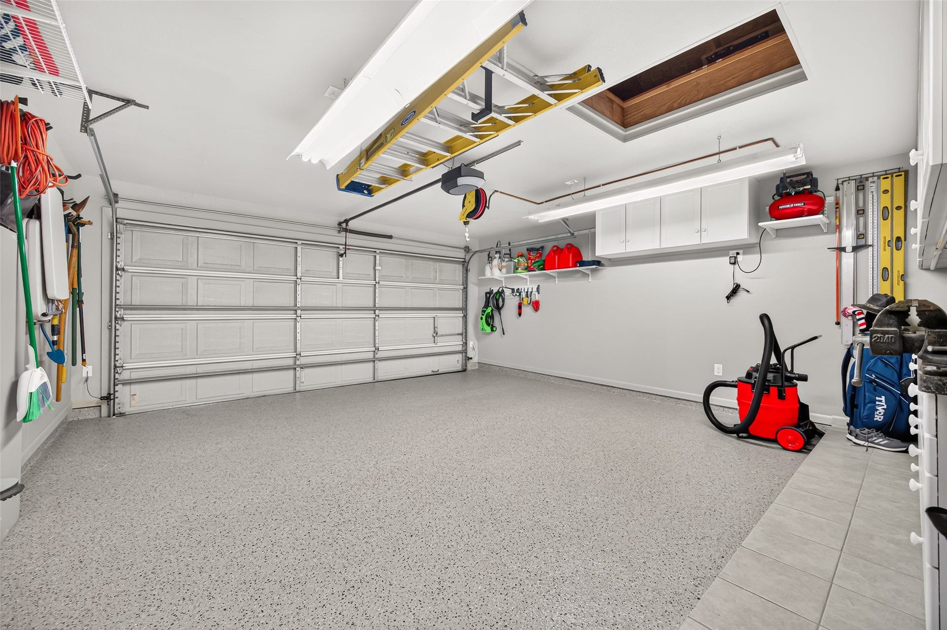 211 Little Summer Drive, Rosenberg, TX 77469 Shelving lifts the compressor off the floor to maximize space. The decked attic connects to the main attic, with shelving and a winch.
