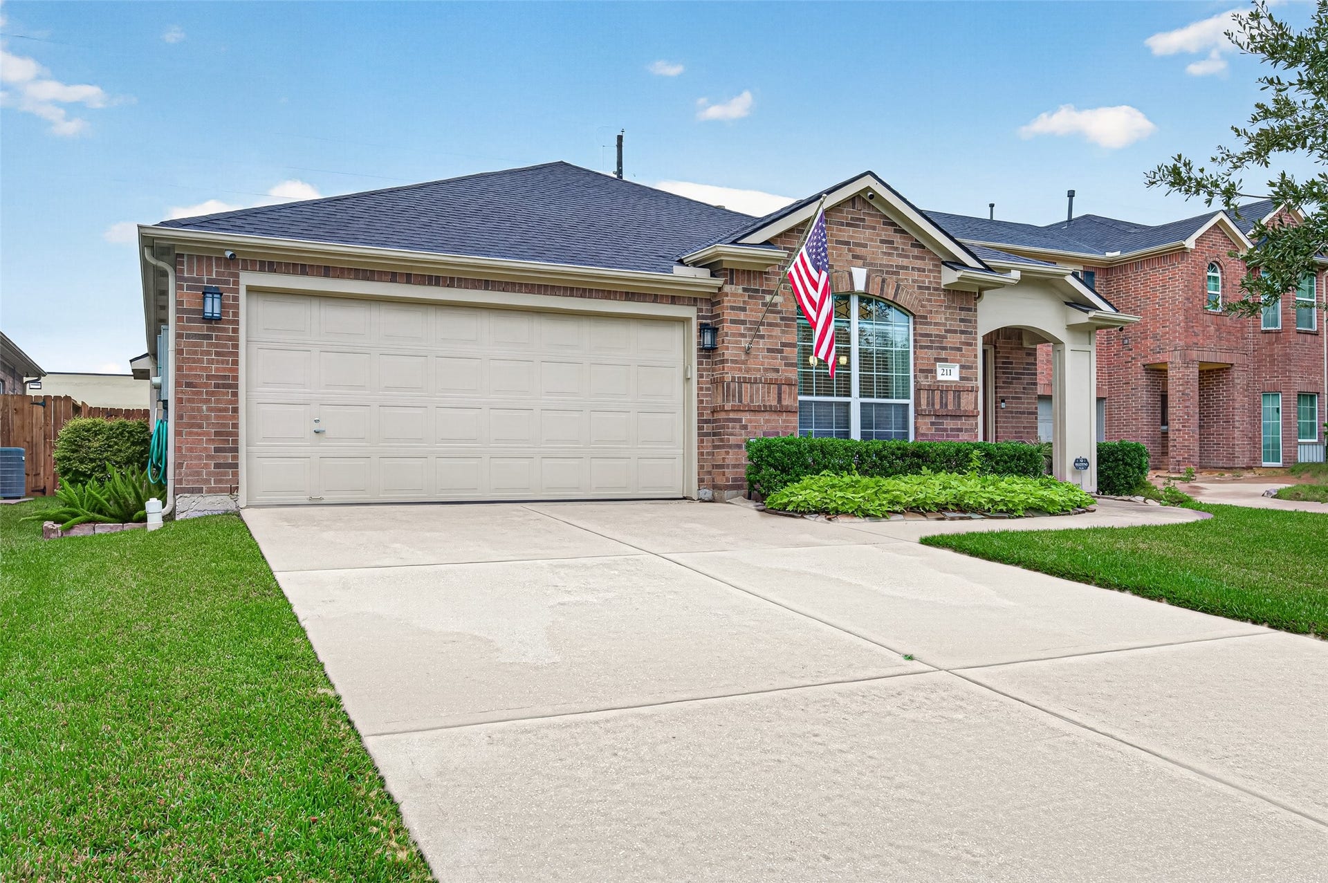 211 Little Summer Drive, Rosenberg, TX 77469 Wide driveway leads to the attached 2-car garage, finished with epoxy floors, built-in work cabinets and plenty of storage.