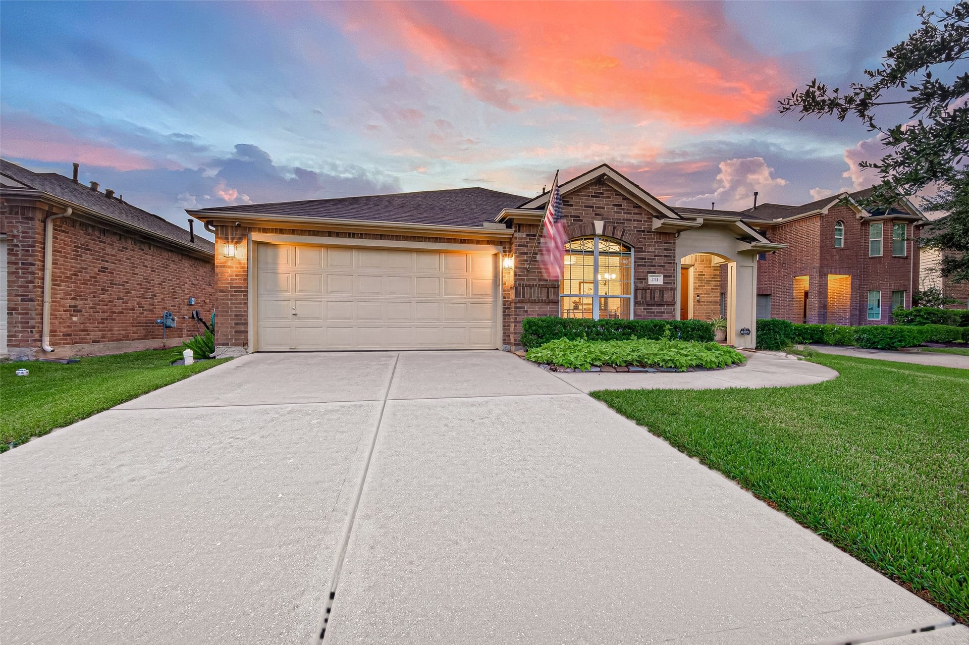 211 Little Summer Drive, Rosenberg, TX 77469 Wide driveway leads to an attached 2-car garage inside includes epoxed flooring, work cabinets and an abundance of storage.
