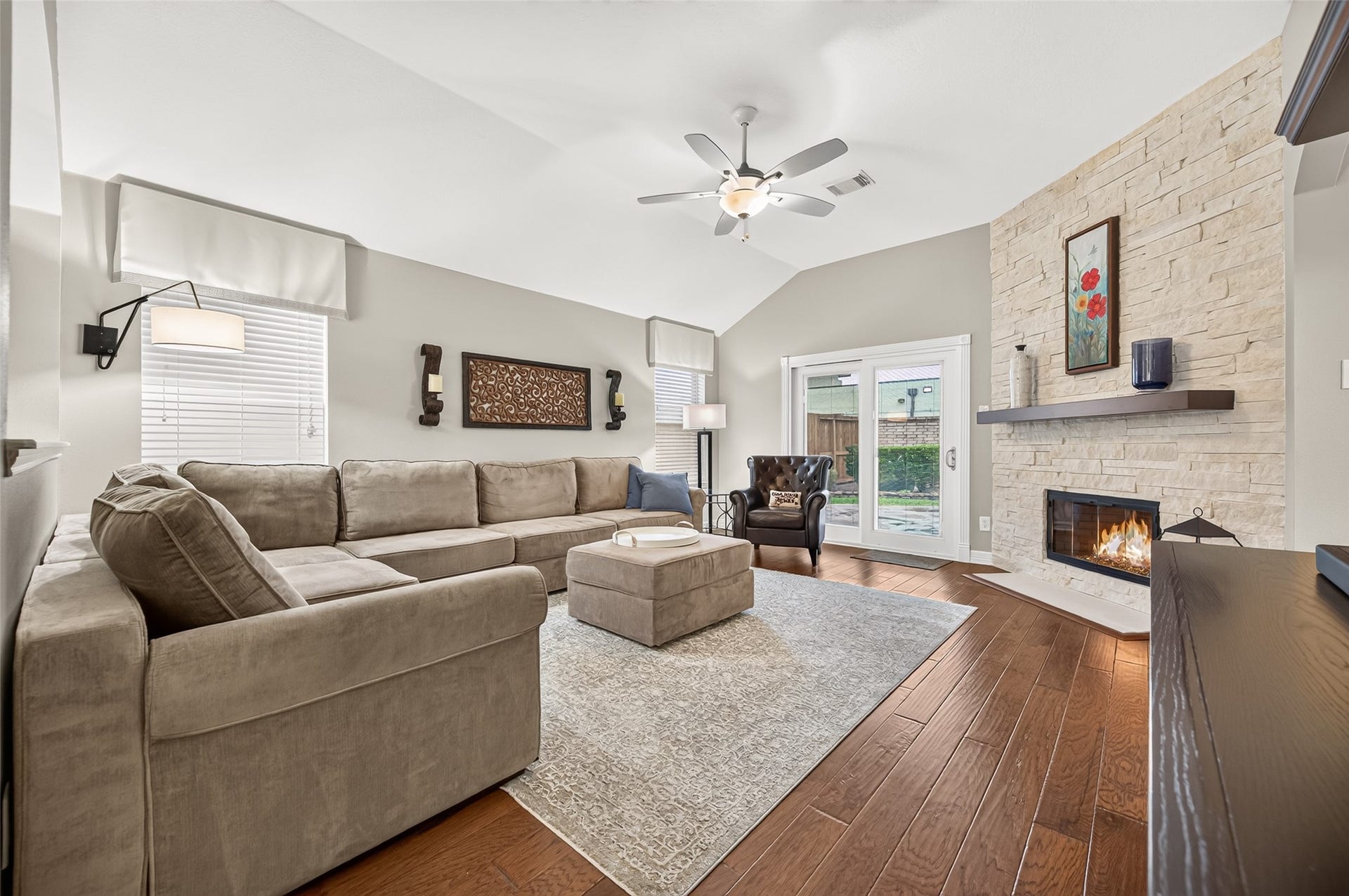 211 Little Summer Drive, Rosenberg, TX 77469 Family room with stone fireplace, patio door was replaced with a sliding glass door that brings in natural light.