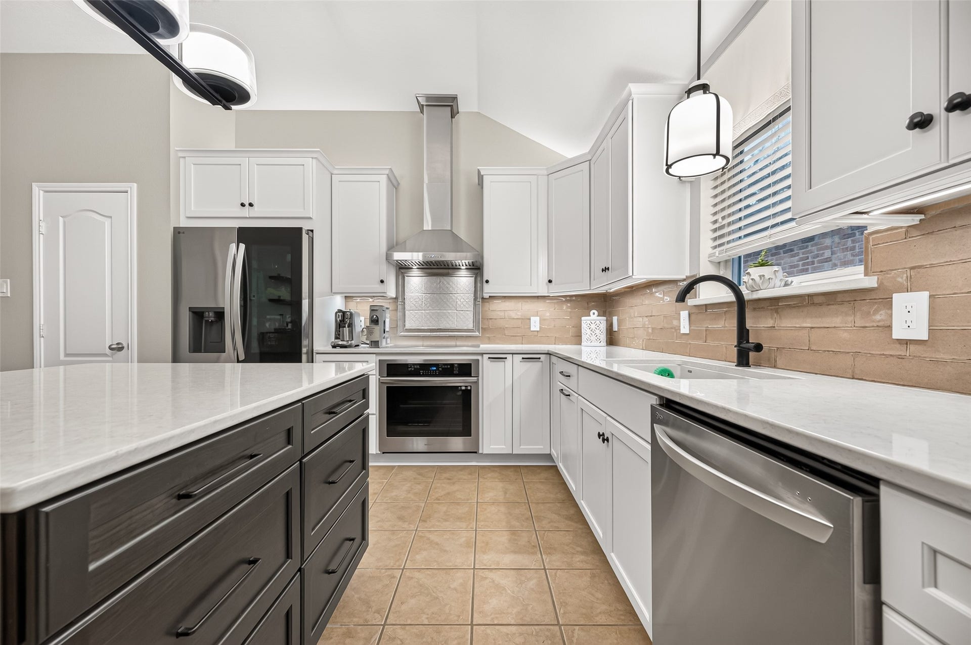 211 Little Summer Drive, Rosenberg, TX 77469 Custom kitchen updated in 2023 with shaker-style cabinetry, deep pot drawers, quartz countertops, an updated backsplash and stainless vent hood. All appliances are 2023, with all-updated lighting including under-cabinet lights.