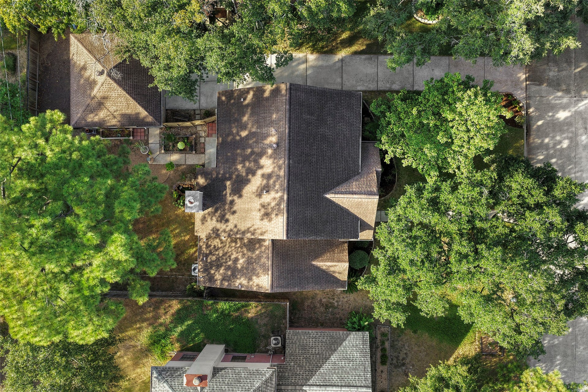 2631 Woodsboro Drive, Spring, TX 77388 Charming home nestled among mature trees, offering a spacious driveway and a cozy backyard retreat.