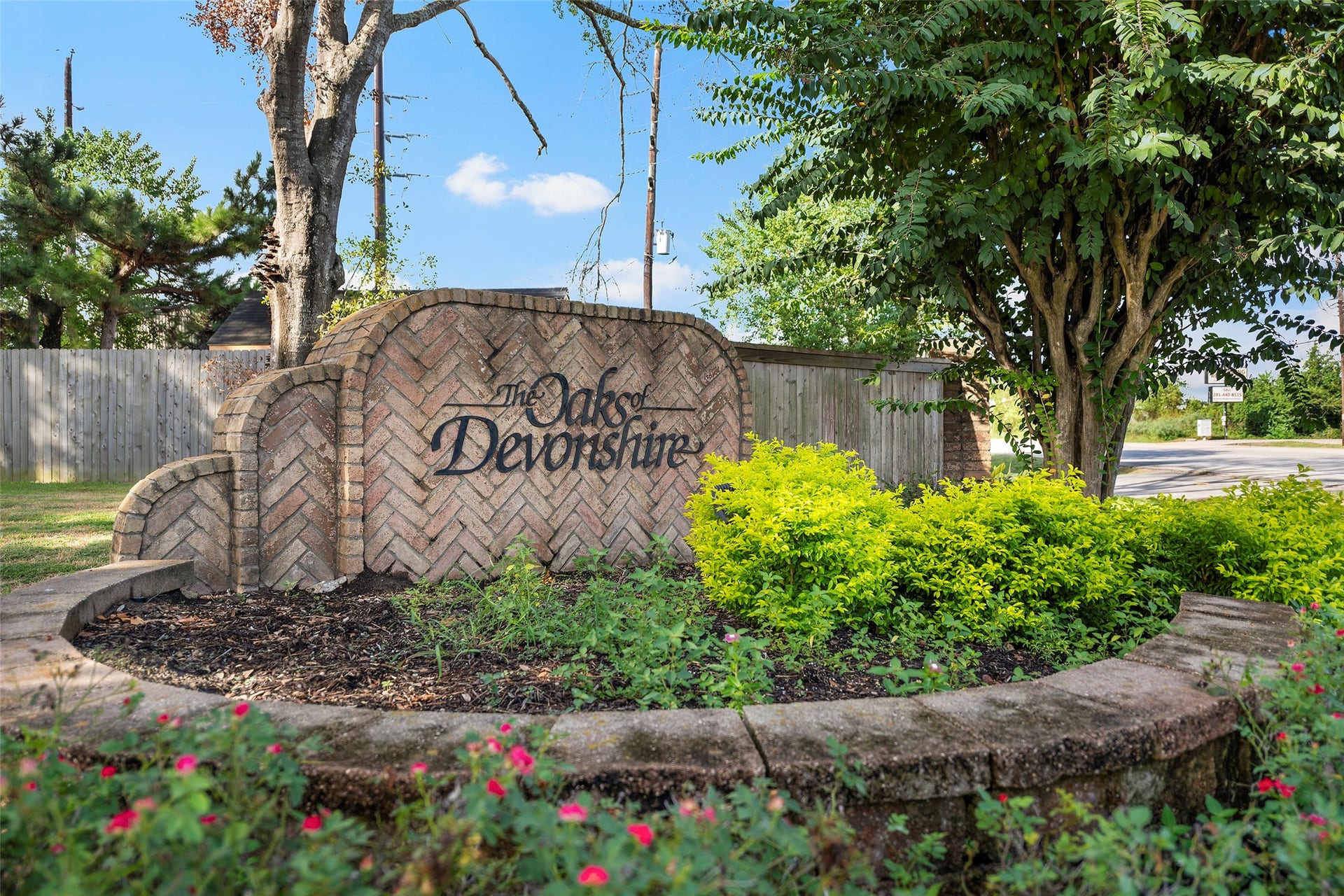 2631 Woodsboro Drive, Spring, TX 77388 Welcome to The Oaks of Devonshire, a charming neighborhood entrance surrounded by lush greenery and vibrant landscaping, offering a warm and inviting community atmosphere.