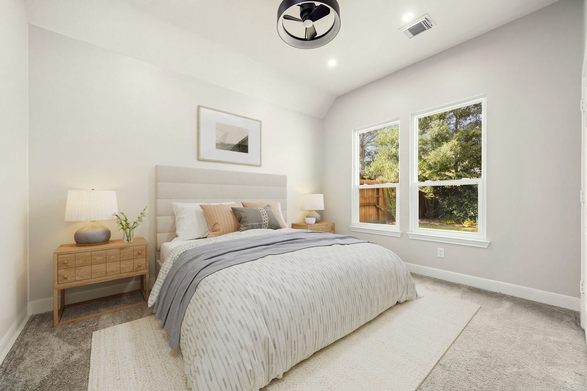 4110 Garden Cove Court, Katy, TX 77494 This welcoming secondary bedroom features neutral walls, plush carpeting, a modern ceiling fan, and high ceilings that create an open, airy feel. Large twin windows offer a serene view of the outdoor greenery while filling the space with beautiful natural lightmaking it ideal for family, guests, or a creative space.