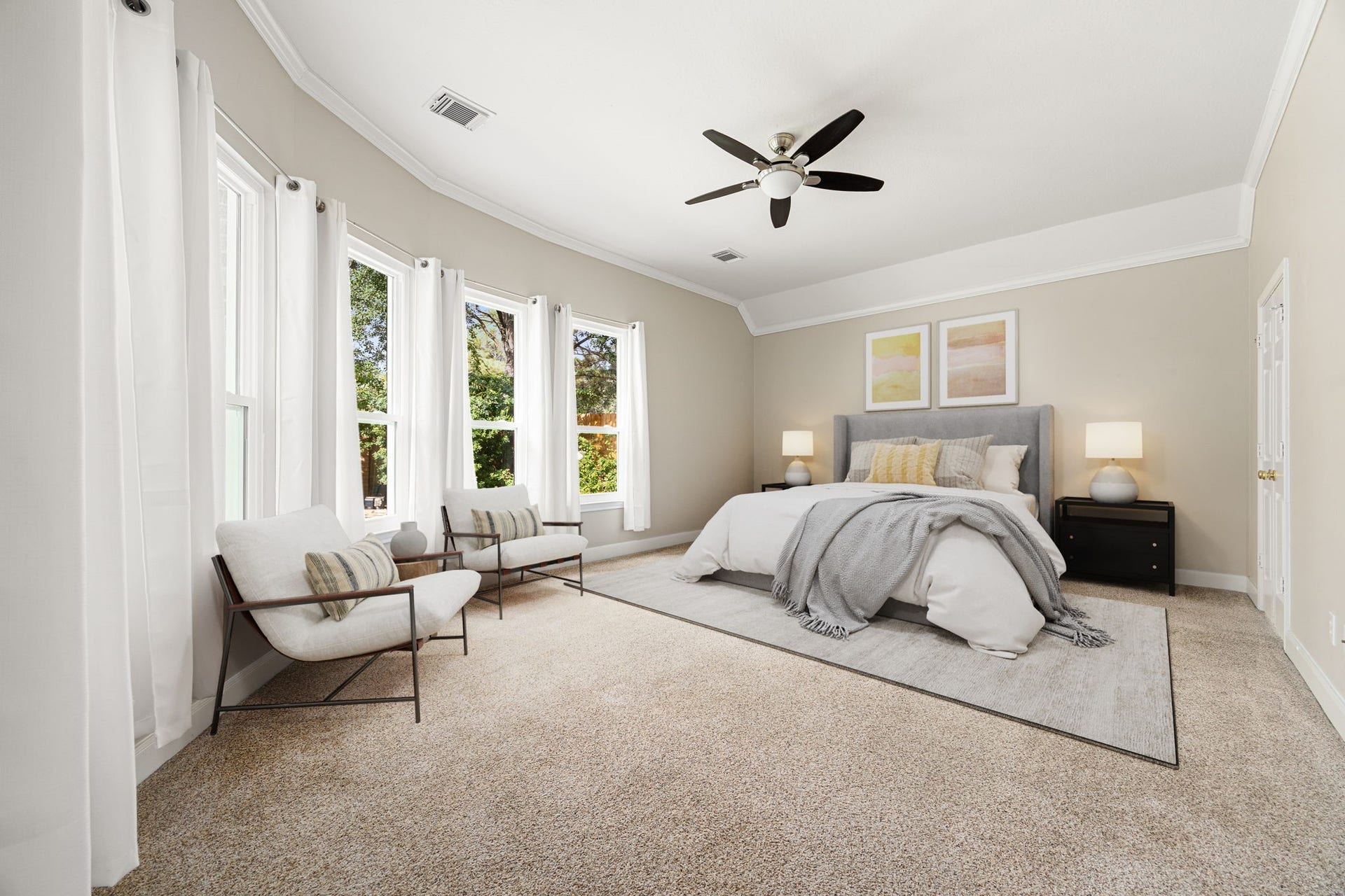 4110 Garden Cove Court, Katy, TX 77494 This sprawling bedroom features a striking curved wall of large bay windows that pour in beautiful natural light. Complete with elegant tray ceilings, a modern ceiling fan, and ample space for a cozy reading nook or sitting area, it offers a peaceful, spa-like escape at the end of the day.
