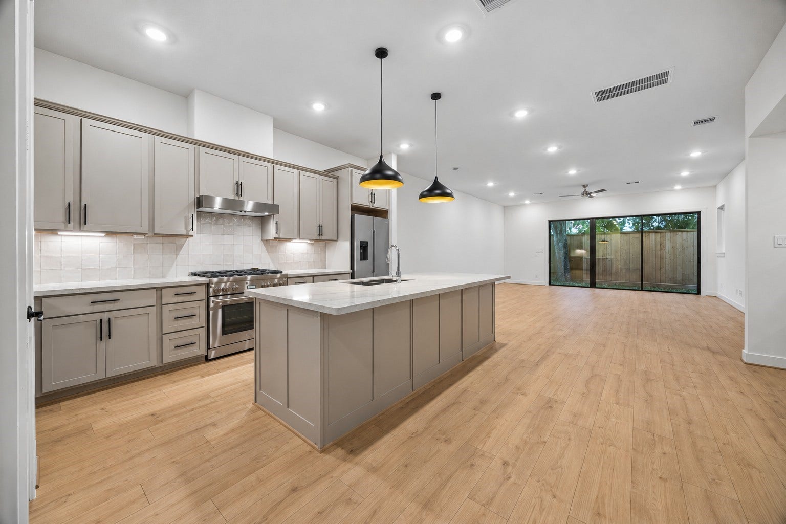5018 Schuler Street, Houston, TX 77007 Beautiful open-concept first-floor living featuring a spacious kitchen with an oversized island, modern finishes, and a seamless flow into the dining and living areas.