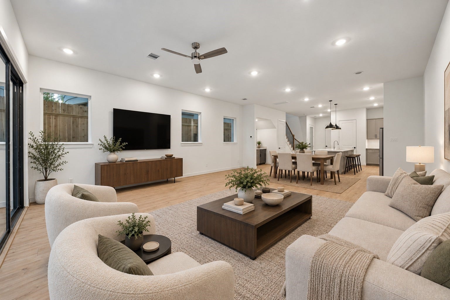 5018 Schuler Street, Houston, TX 77007 Digitally staged spacious living area featuring a comfortable seating arrangement, modern finishes, and an open layout that flows seamlessly into the dining area and kitchen.