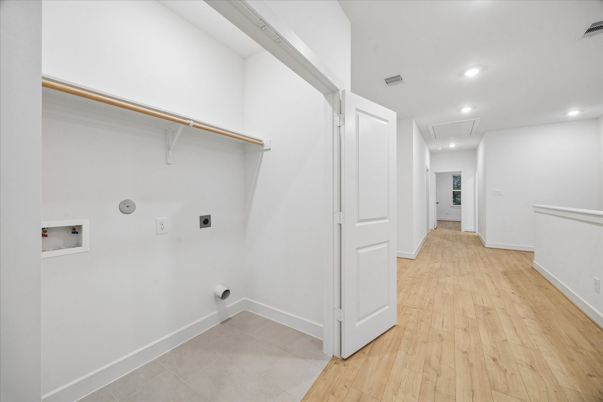 5018 Schuler Street, Houston, TX 77007 Convenient upstairs laundry room with built-in shelving and washer/dryer connections, located near the bedrooms for easy access.