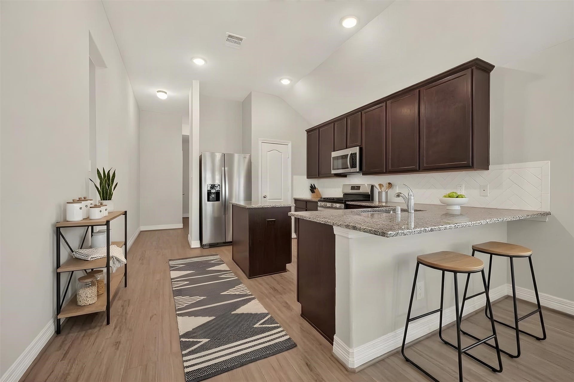 Open concept floor plan from kitchen to living [virtually staged]