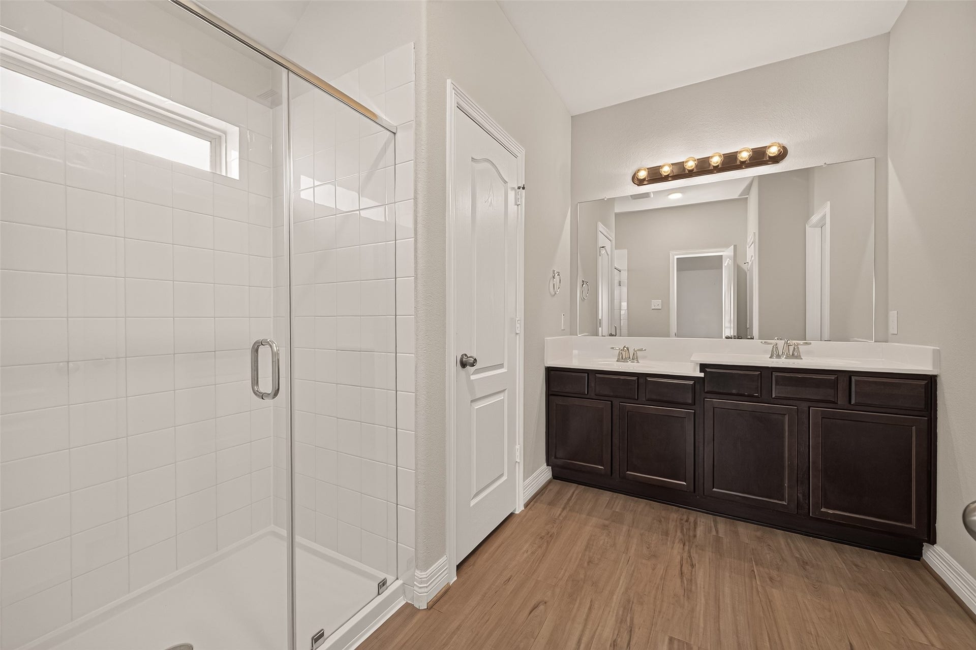 7423 Sunlit Harbor Drive, Cypress, TX 77433 Spacious primary bathroom featuring a large walk-in shower and a double vanity, designed for convenient everyday use.