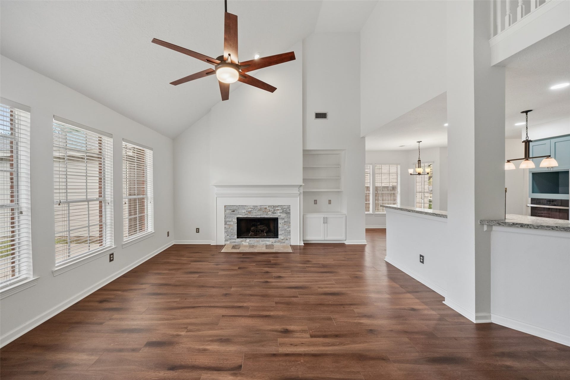 1123 Summer Brook, Sugar Land, TX 77479 Anchored by a warm fireplace and framed by expansive windows, this living space invites you to slow down and stay awhile. The open layout and soaring ceilings create a sense of airiness, while the natural light brings the room to life throughout the dayperfect for both quiet evenings and lively gatherings.